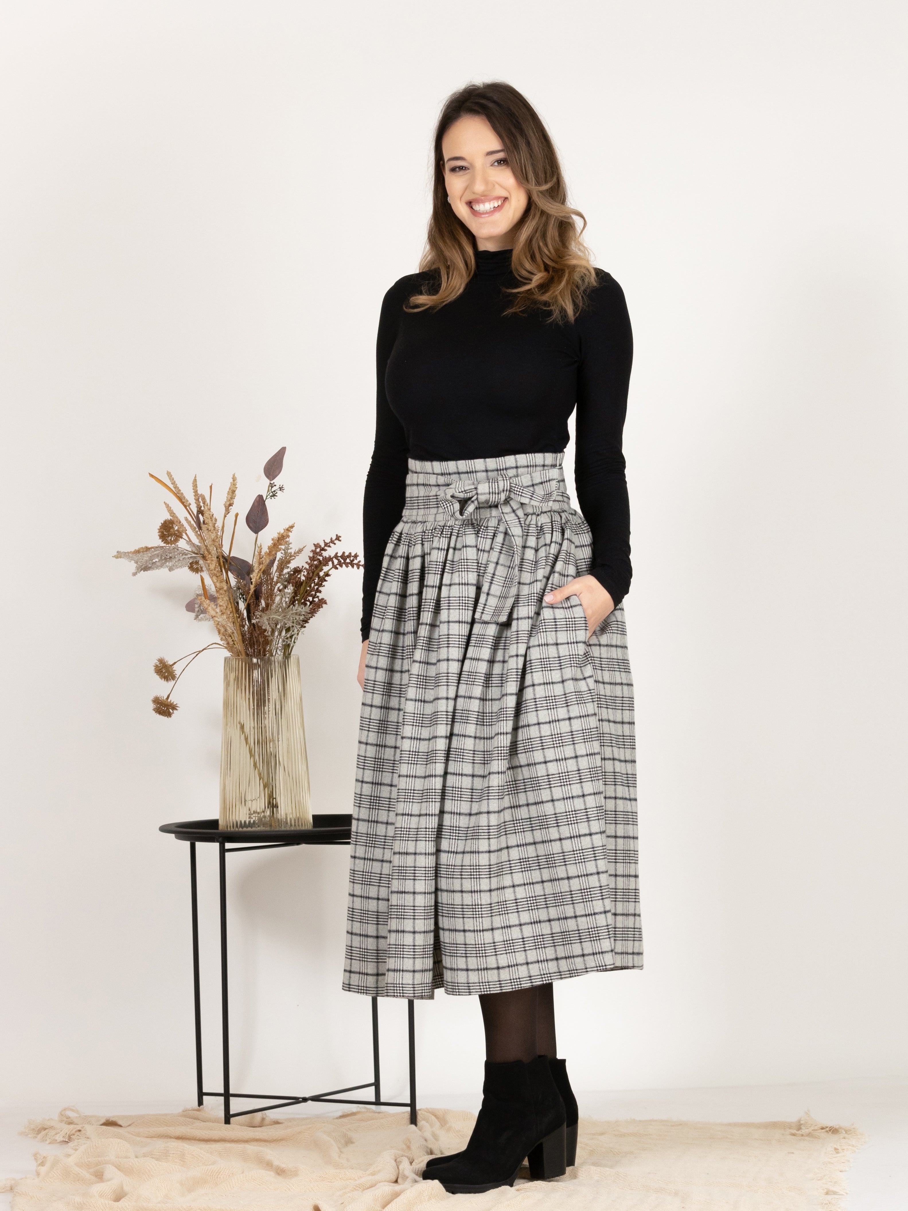Front profile of Wool Midi Plaid Skirt with High Waisted Bow and Pockets
highlighting the loose flare style