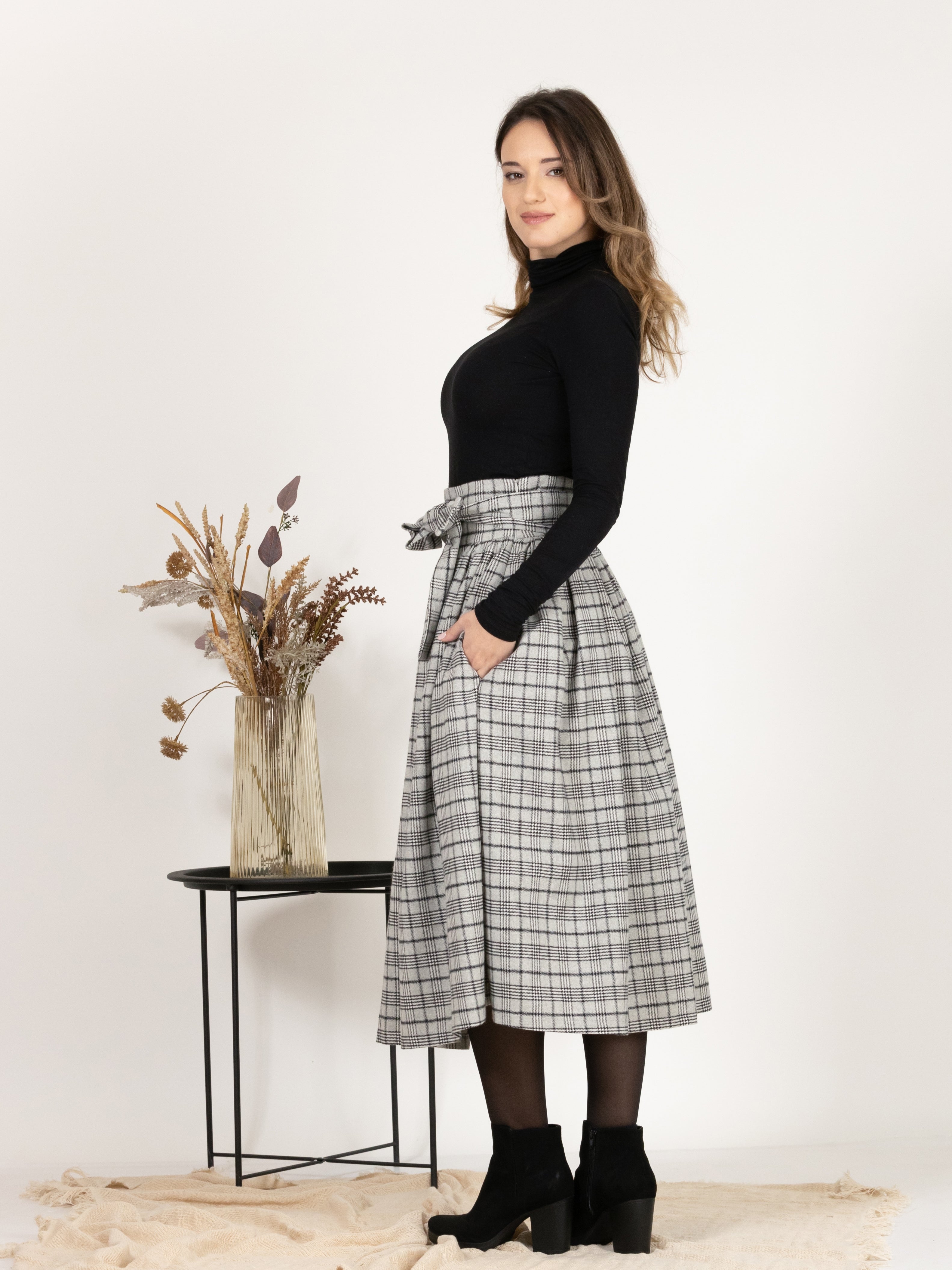 Side profile of Wool Midi Plaid Skirt with High Waisted Bow and Pockets, highlighting the flow