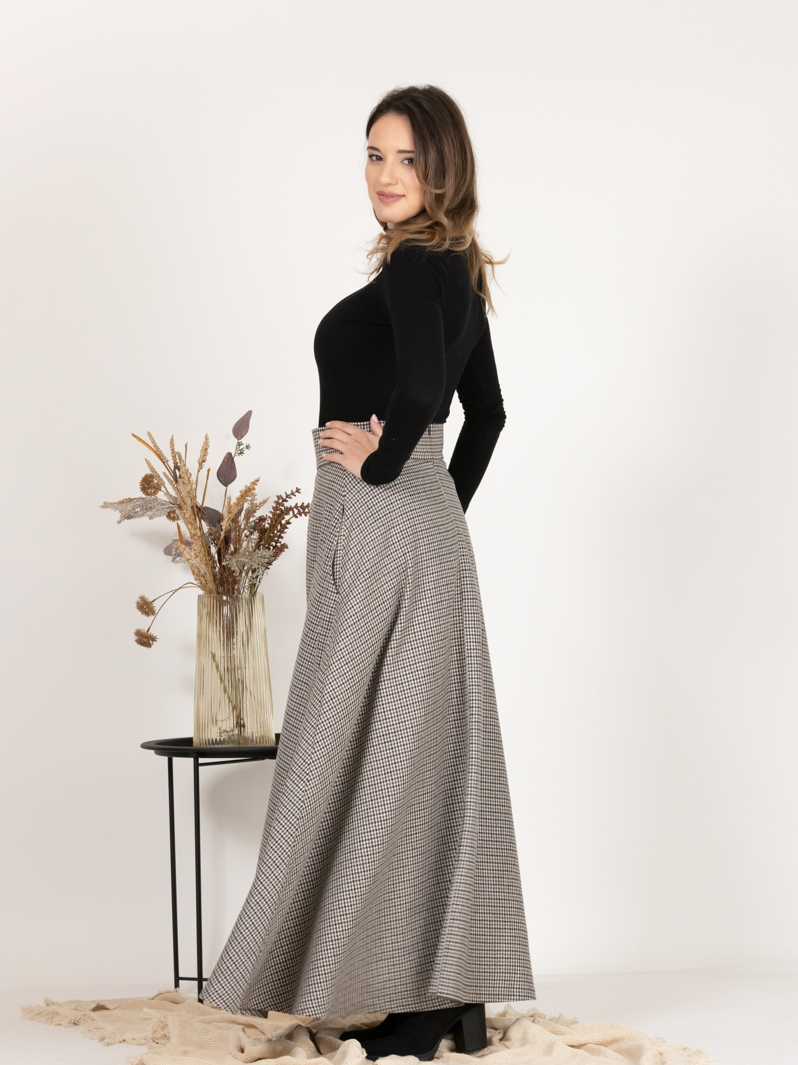 Side view of Wool Maxi A-Line Skirt with Pockets in Houndstooth Pattern
emphasizing the flare style