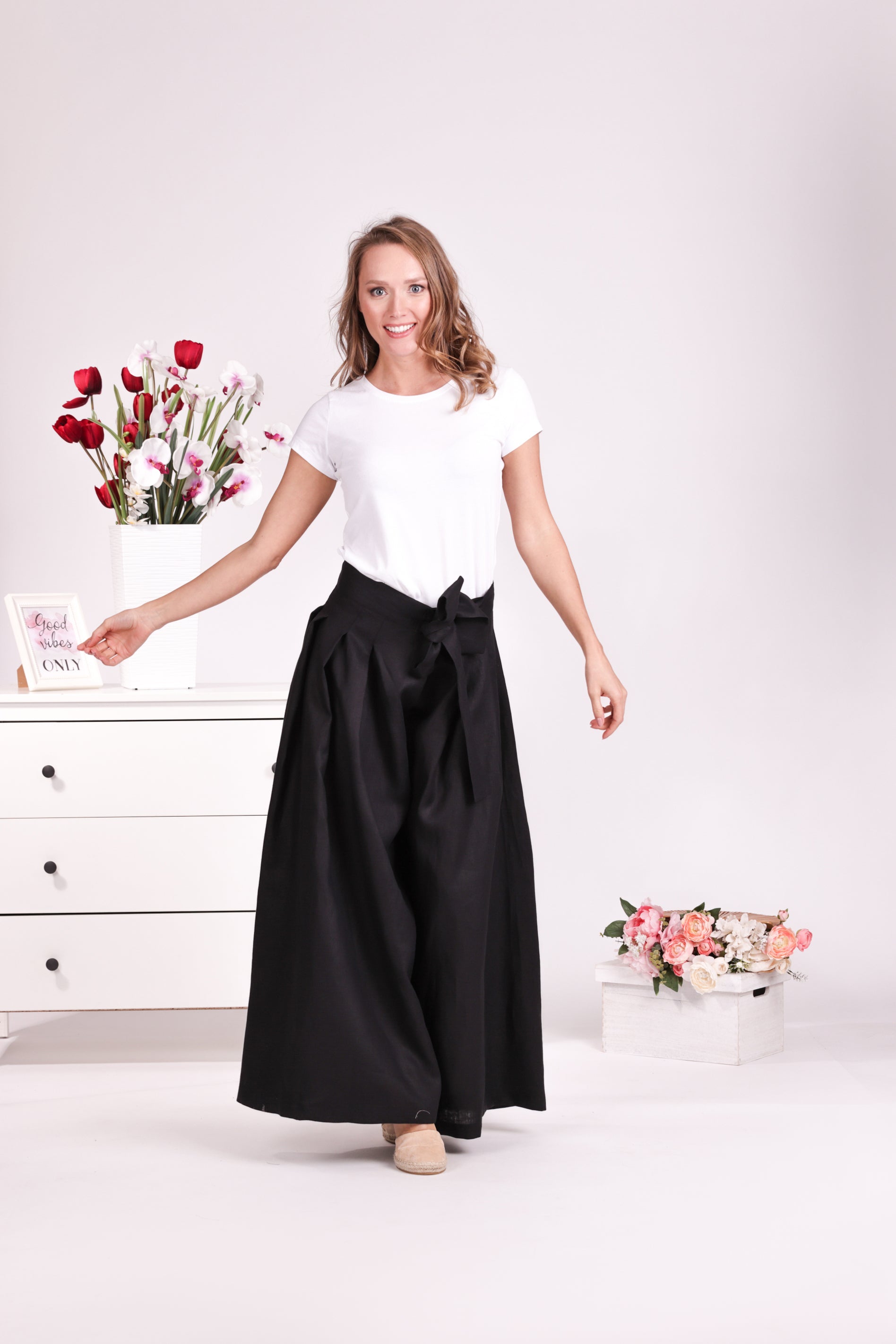 Relaxed black linen trousers with bow detail