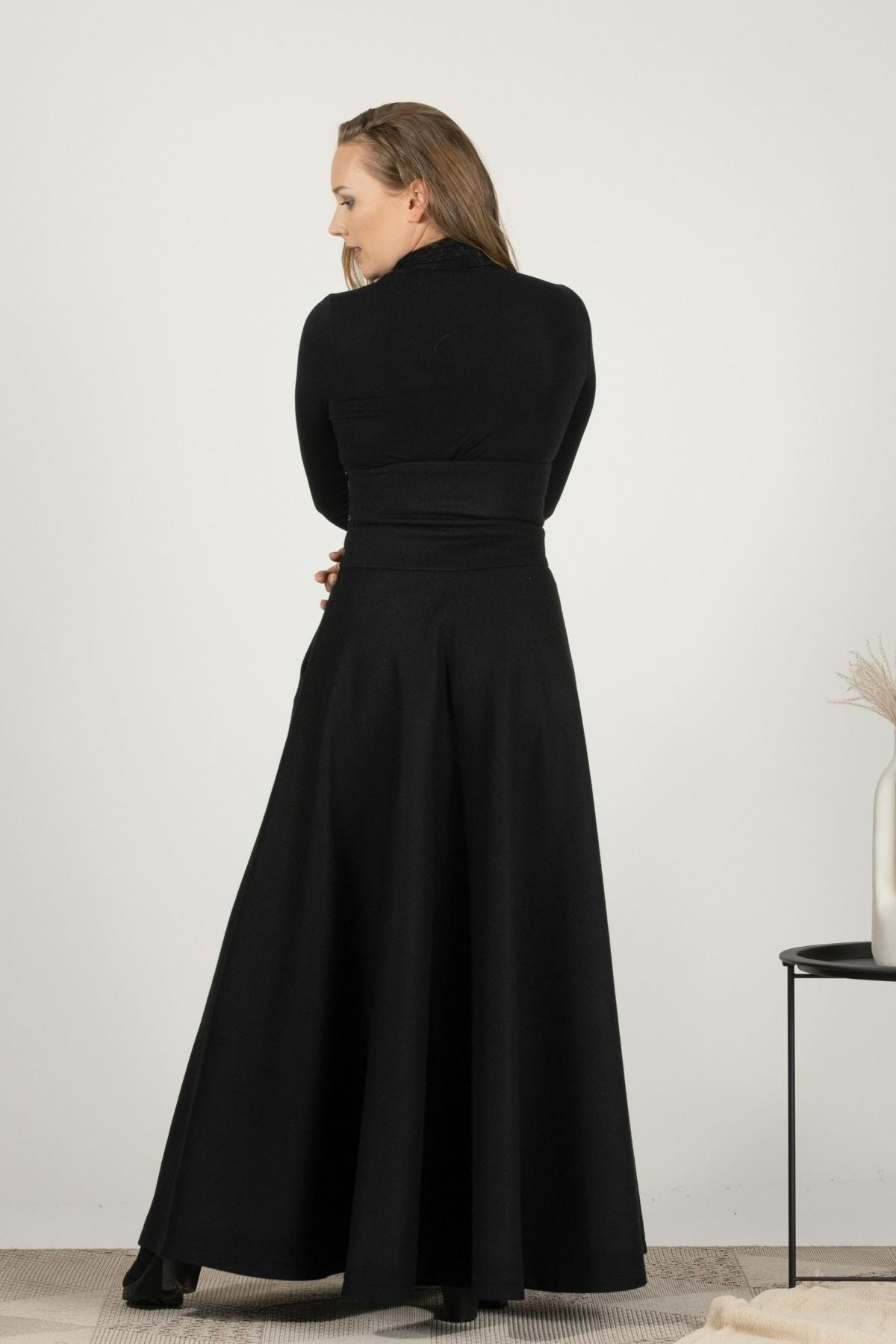 High-waisted black wool maxi with timeless design
