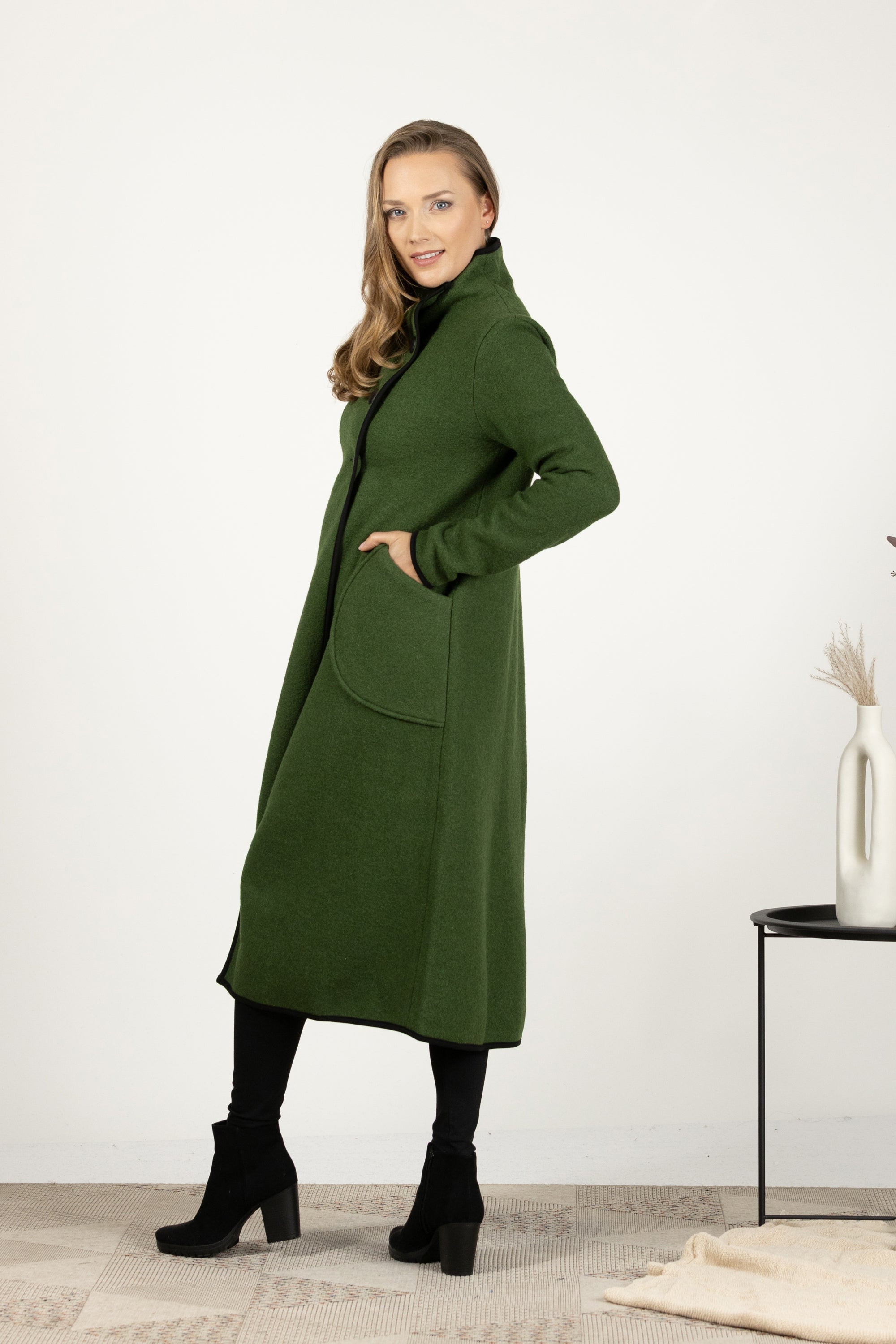 Side view of dark green wool coat with classic silhouette