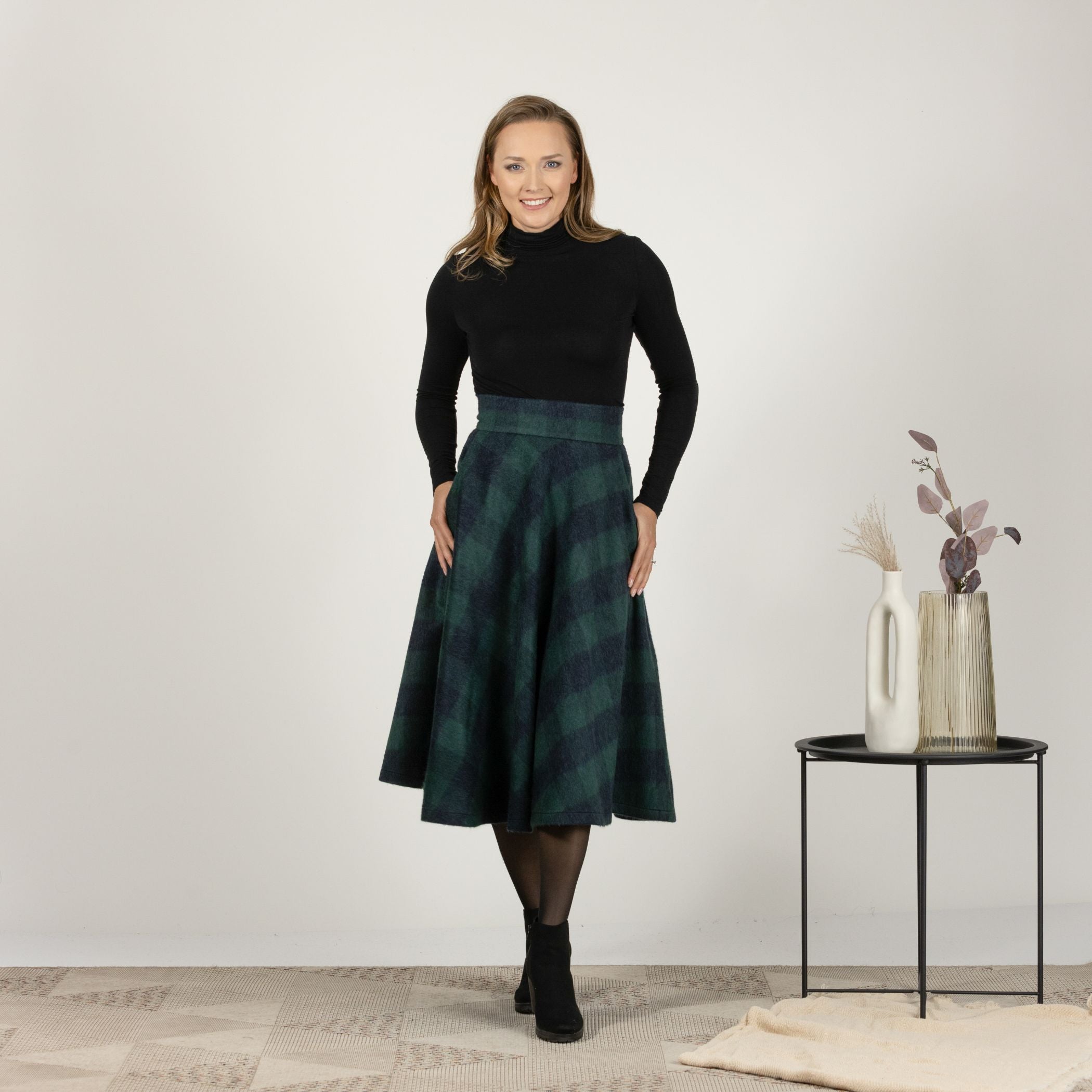 Front view of the Green Plaid High Waisted Wool Midi Skirt, showcasing the classic plaid pattern and high-waisted silhouette for a flattering fit.