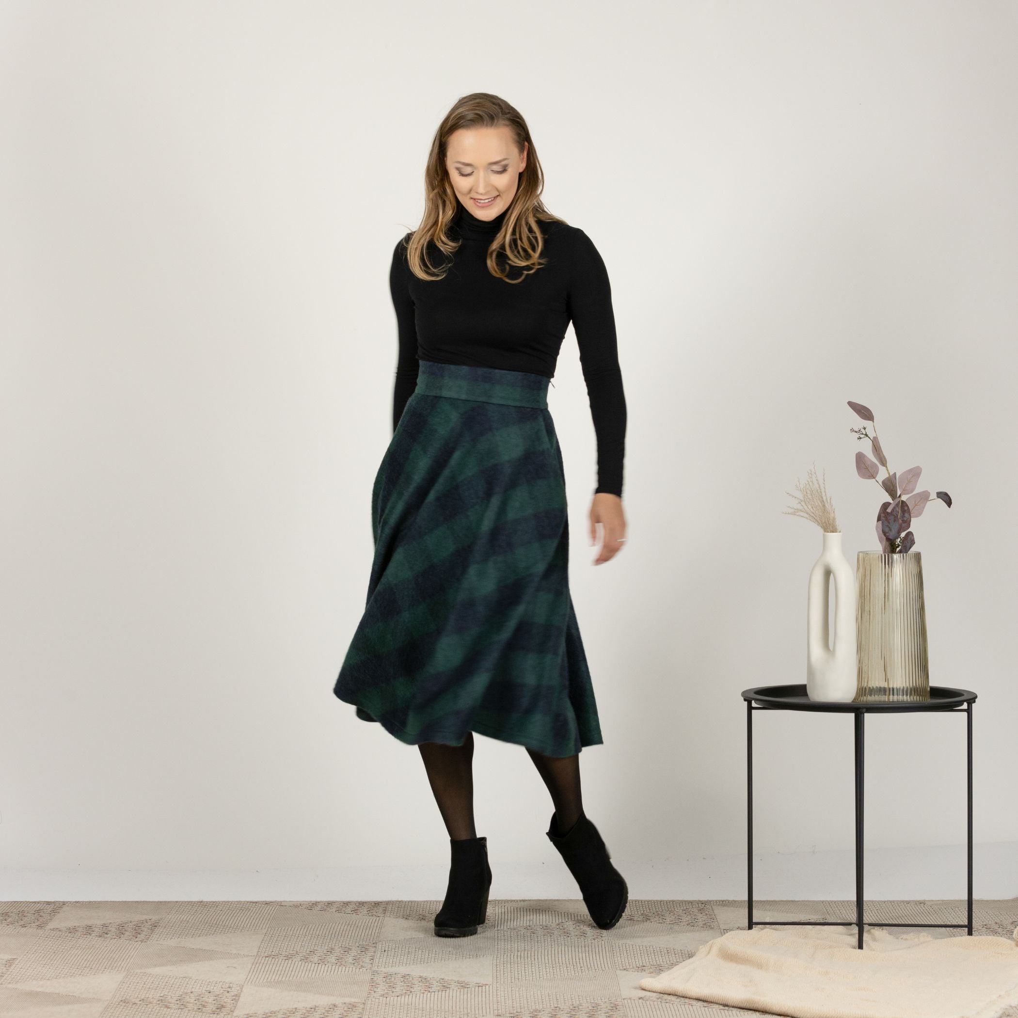 Full-length front view of the Green Plaid High Waisted Wool Midi Skirt, highlighting the soft cool wool fabric and the timeless plaid design.