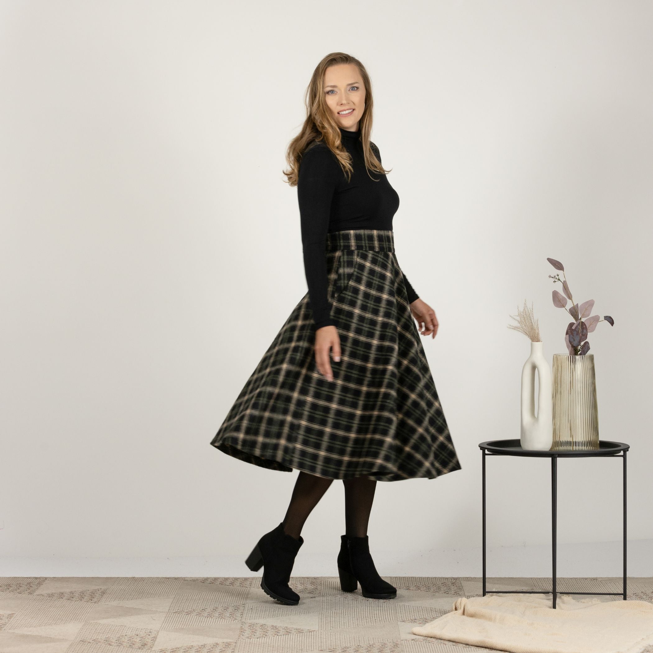 Side view of the Brown Plaid High Waisted Wool Midi Skirt in motion, showcasing the fluid movement and classic plaid style.