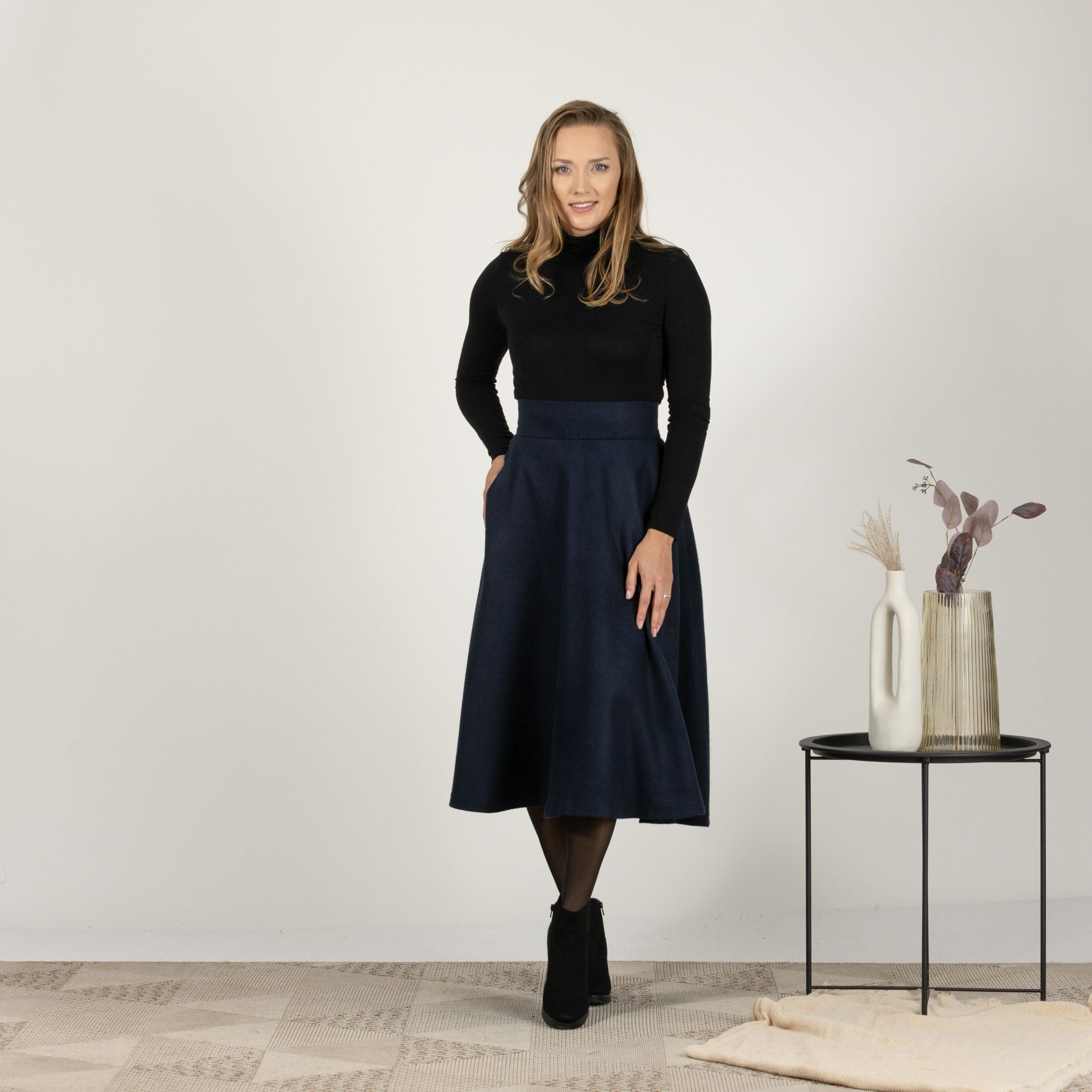 Close-up front view of the Dark Blue High Waisted Wool Midi Skirt, focusing on the fine texture of the wool fabric and the tailored fit.