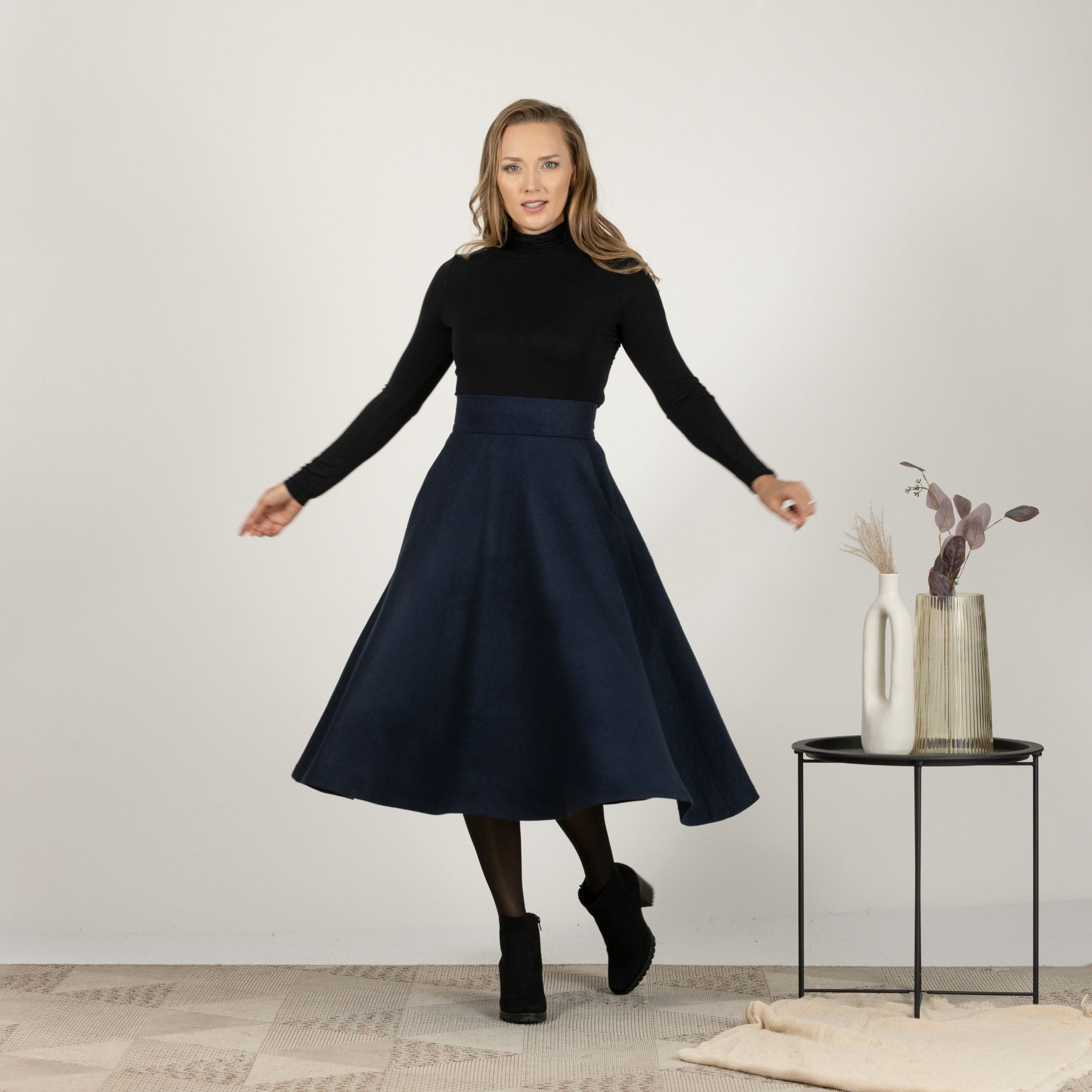 Front view of the Dark Blue High Waisted Wool Midi Skirt, emphasizing the defined waist and elegant drape of the fabric.