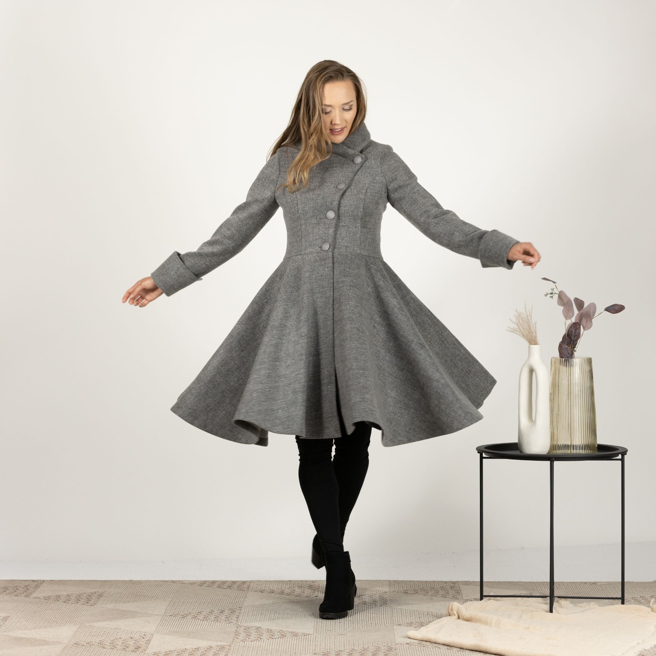 Front view of the Gray A-line Buttoned Winter Coat worn open, revealing the classic A-line shape and warm interior lining.