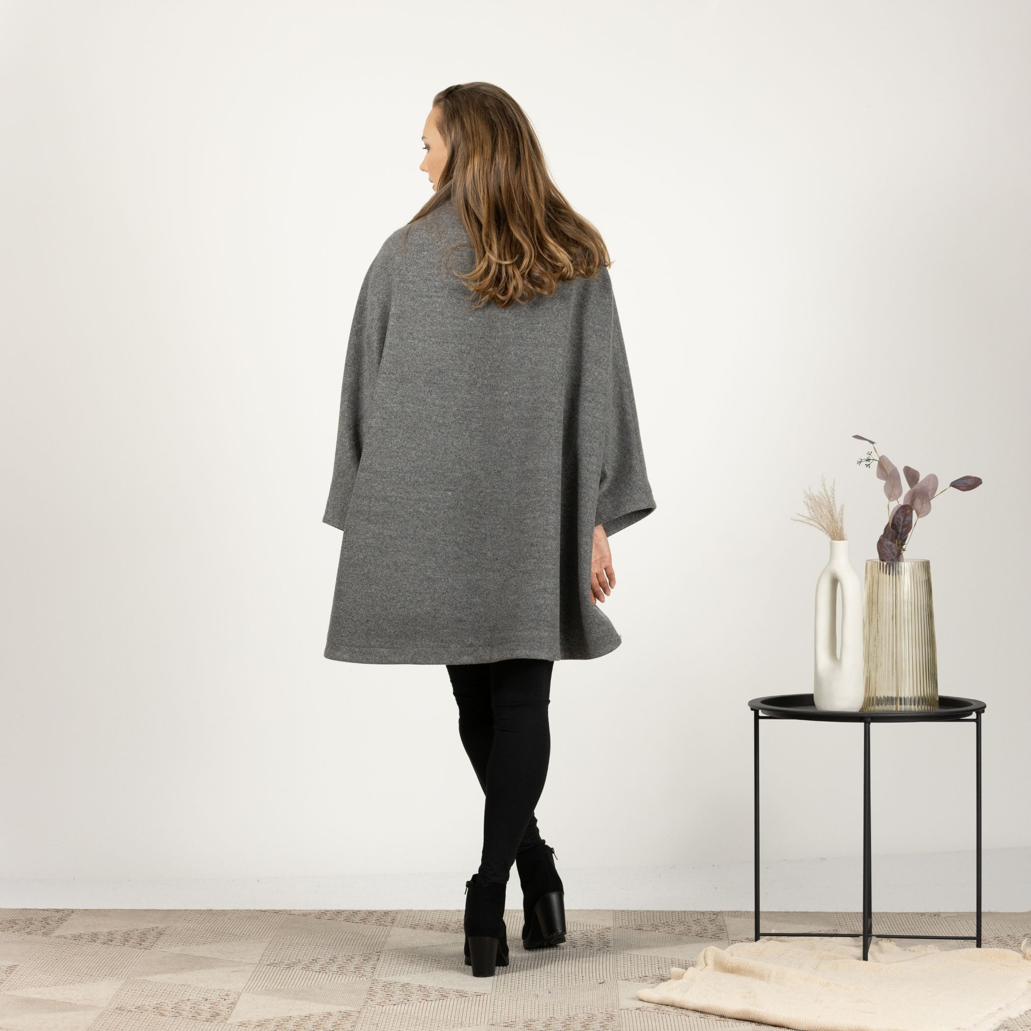 Full-length back view of the Gray Collared Loose Cape Coat, highlighting the smooth drape of the fabric and the elegant above-the-knee length.