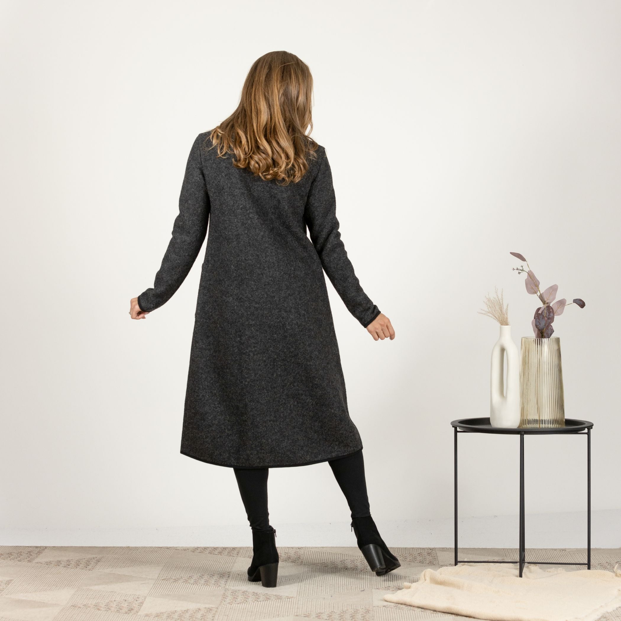 Back view of the Charcoal Boiled Wool Coat with Pockets, emphasizing the classic, seamless design for a timeless, elegant look.