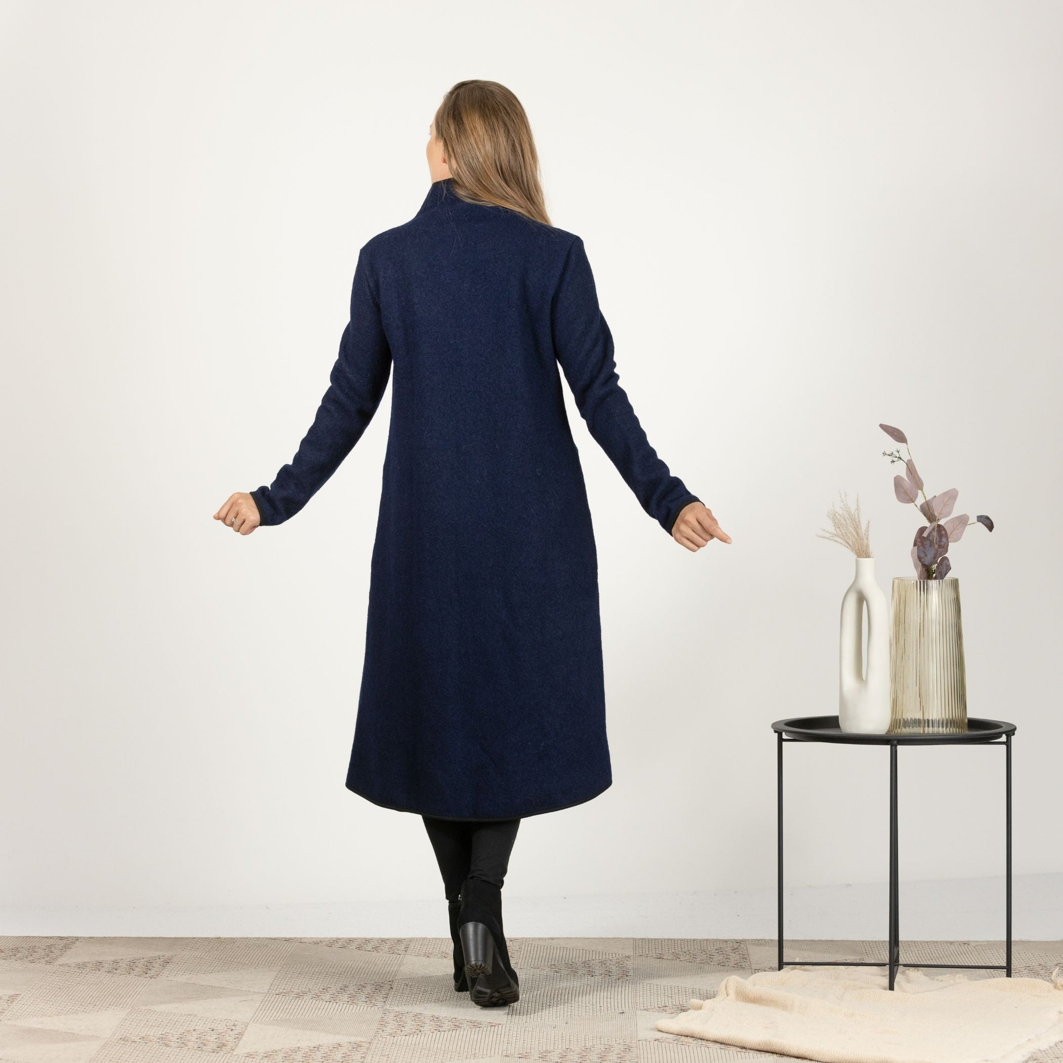 Back view of the Dark Blue Boiled Wool Coat with Pockets, emphasizing the clean lines and seamless design for a timeless look.