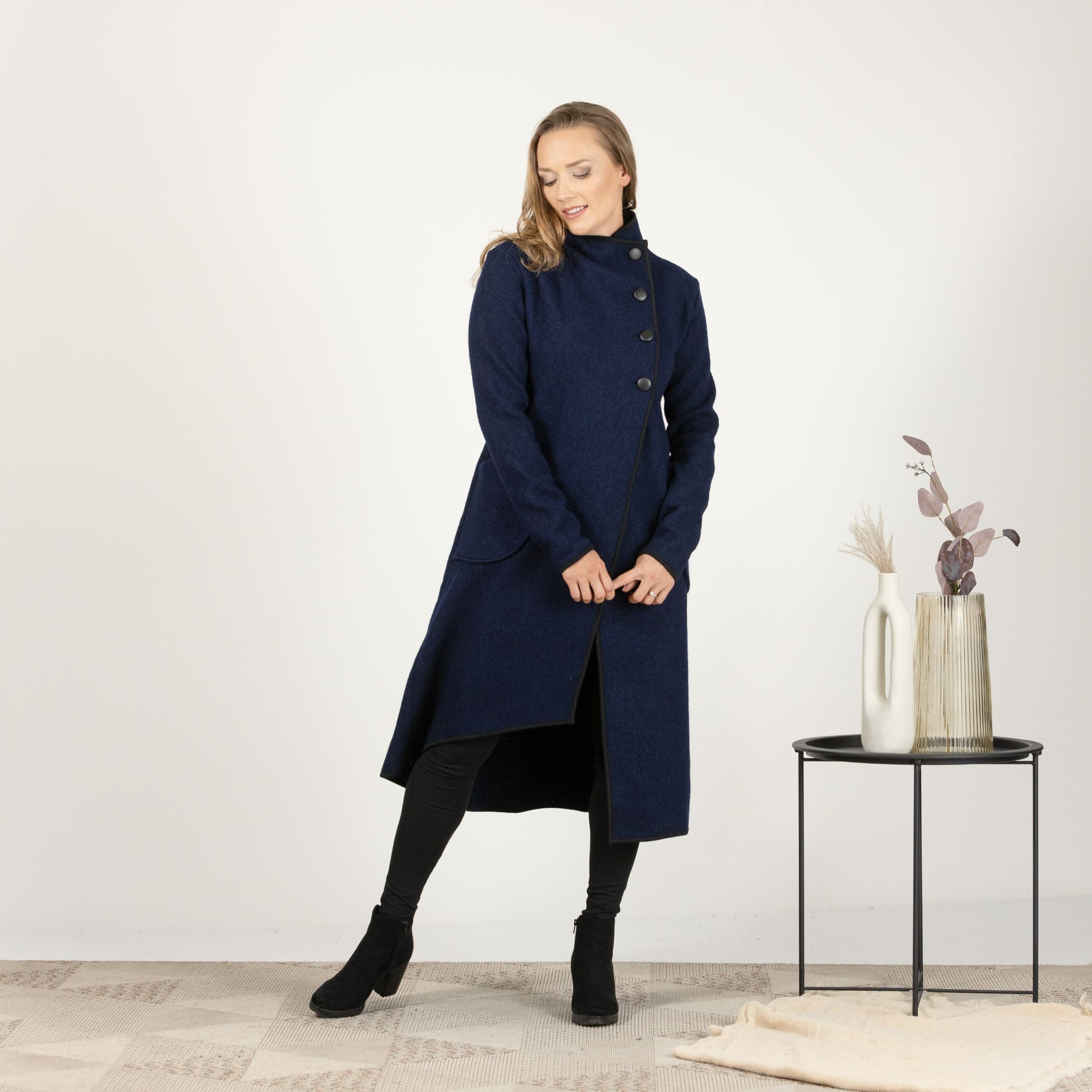 Front view of the Dark Blue Boiled Wool Coat with Pockets in motion, showcasing the fluid movement and warmth of the wool material.