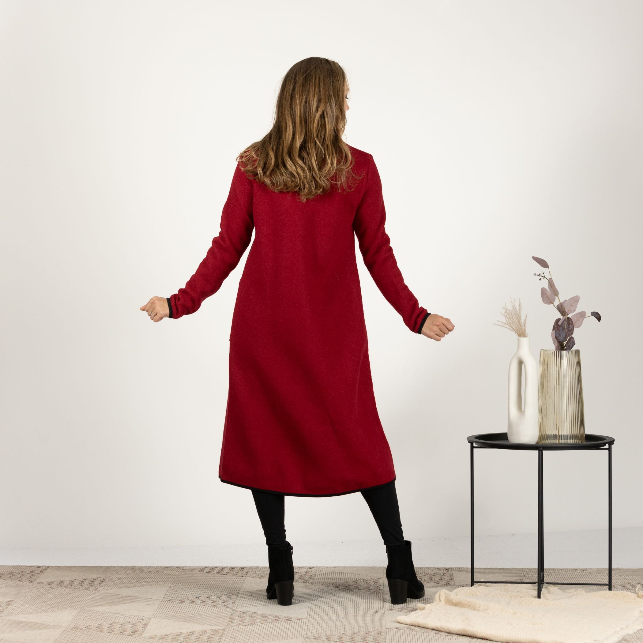 Back view of the Raspberry Boiled Wool Coat with Pockets, emphasizing the clean lines and seamless design for a timeless look.