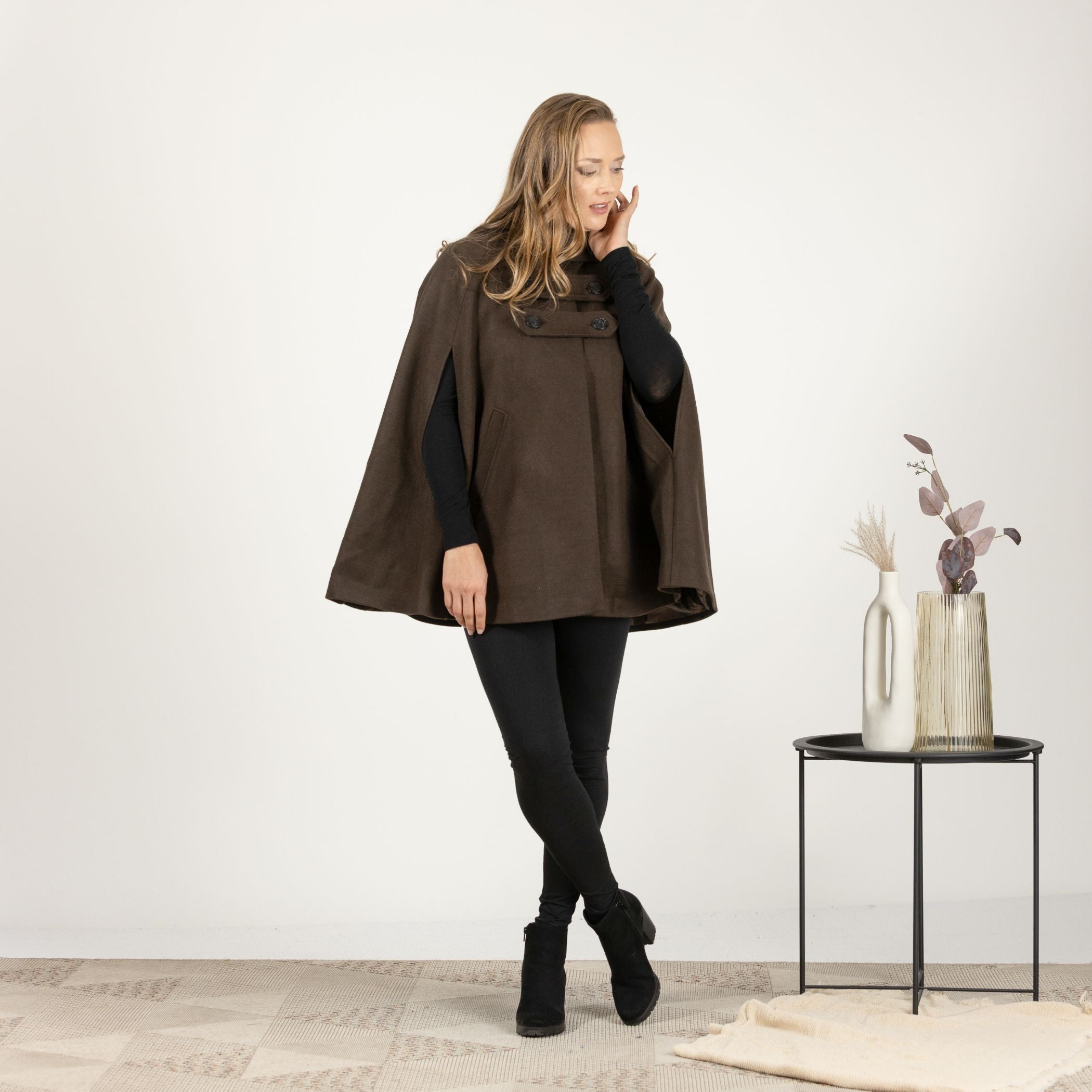 Full-length front view of the Brown Hooded Wool Cape Coat, highlighting the mid-thigh length and front pockets for added functionality.