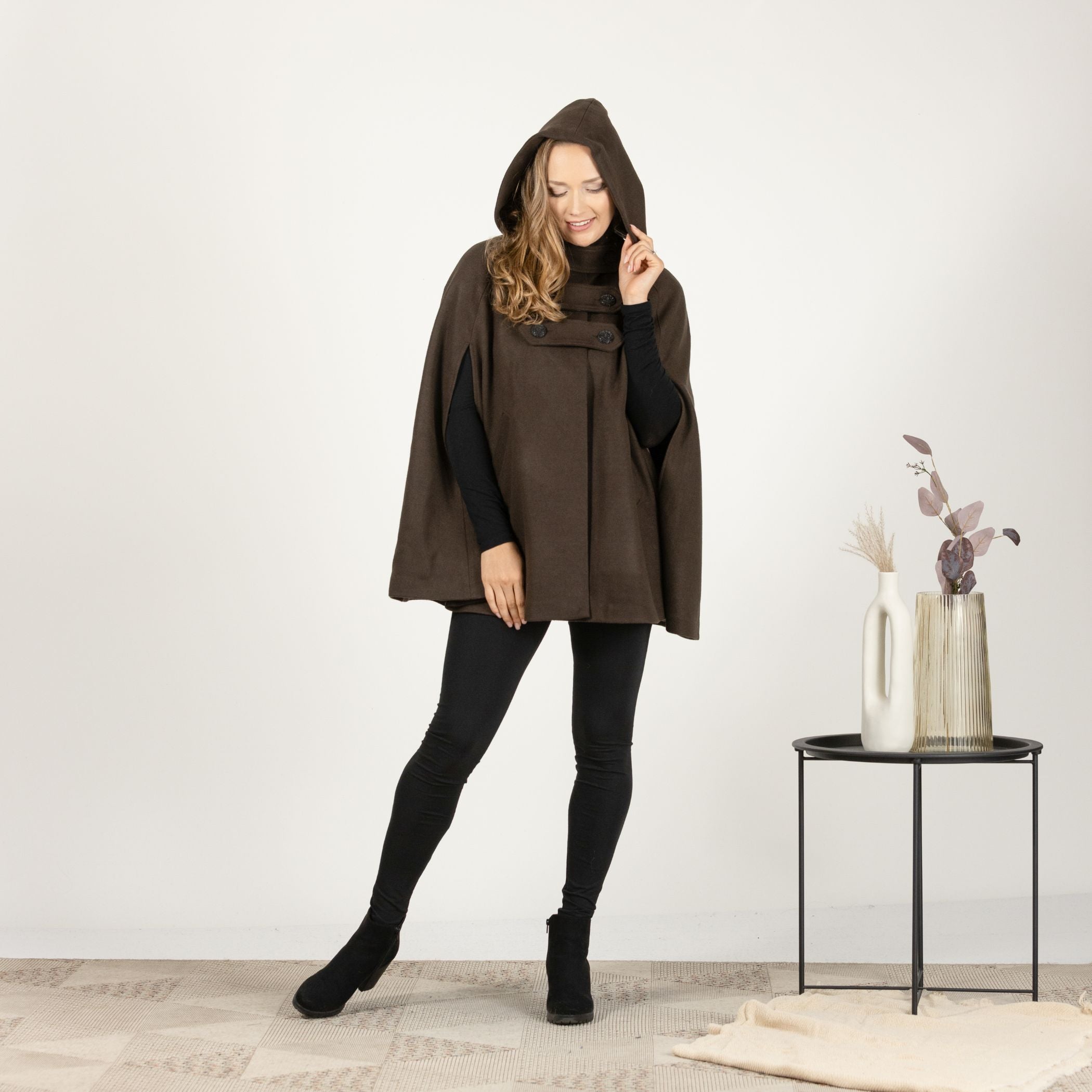 Close-up front view of the Brown Hooded Wool Cape Coat, focusing on the fine texture of the wool blend fabric and the stylish button closure.