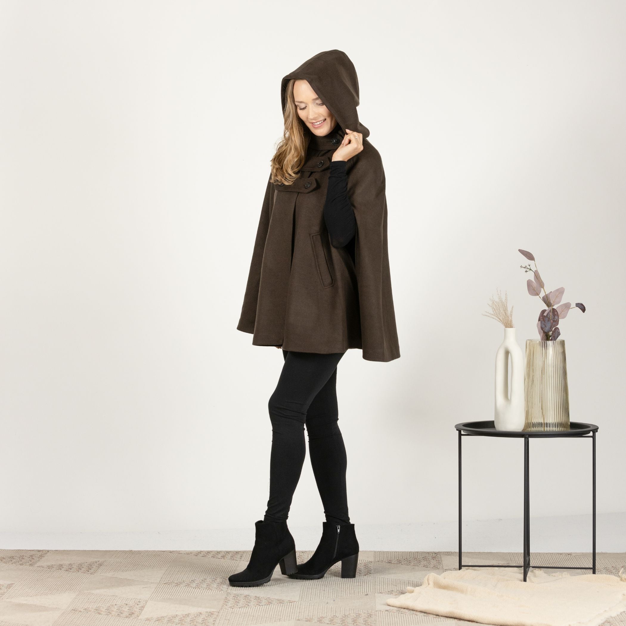 Side view of the Brown Hooded Wool Cape Coat with the hood attached, showing the elegant flow and comfortable fit of the cape design.