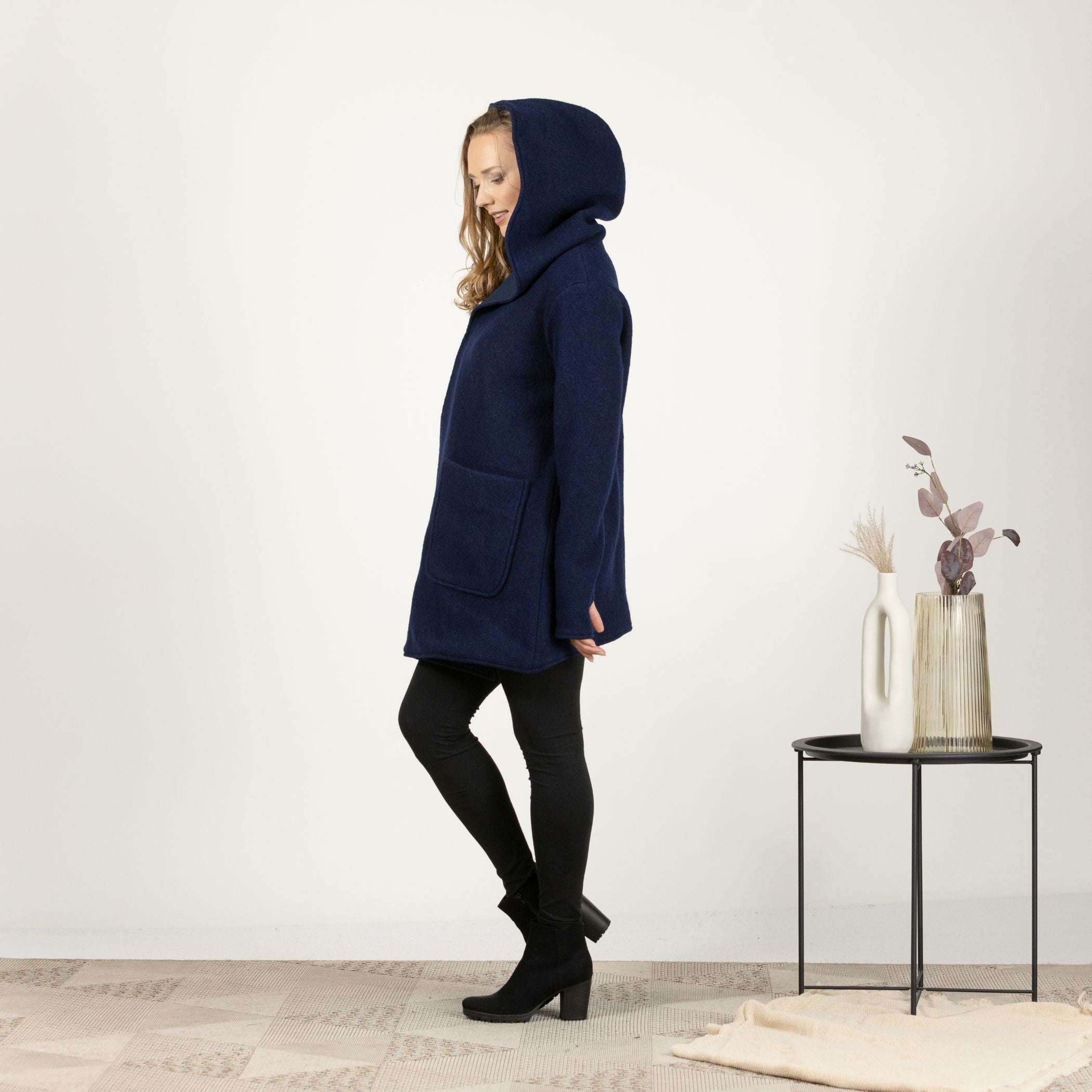 Side view of the Dark Blue Hooded Wool Cardigan with the hood up, emphasizing the practical and elegant design.