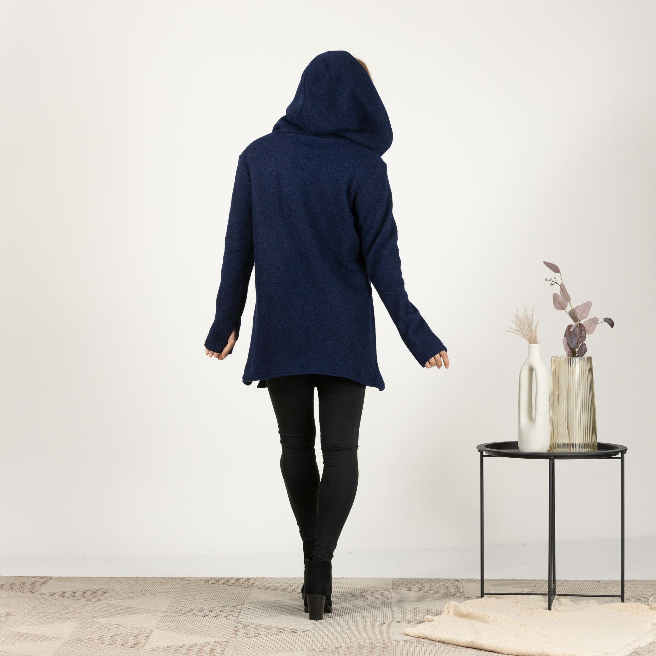 Back view of the Dark Blue Hooded Wool Cardigan, showcasing the seamless design and full-length hood for a modern touch.