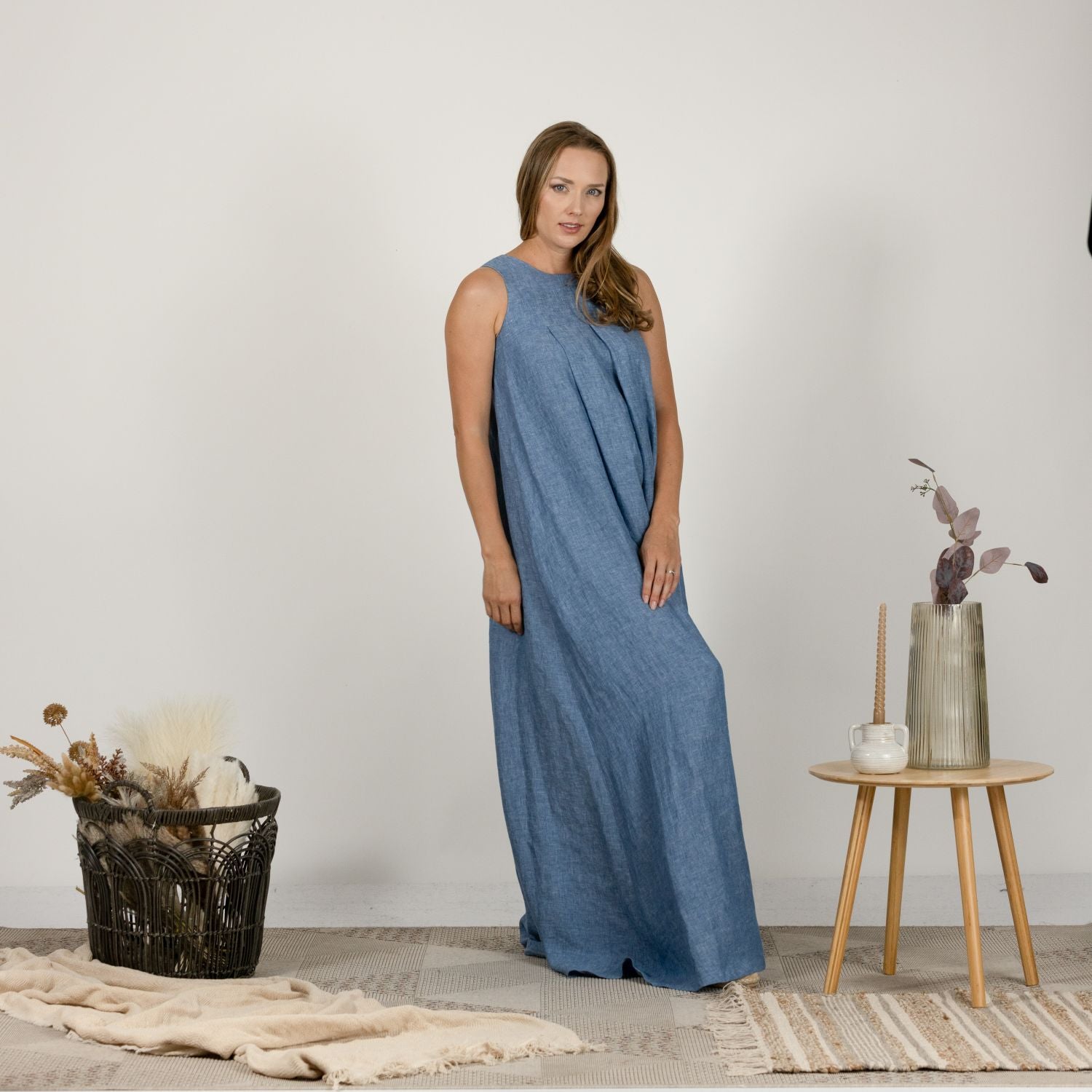 Side view of the Loose Linen Maxi Dress in Blue Melange, showcasing its flattering drape and functional side pockets for added convenience."