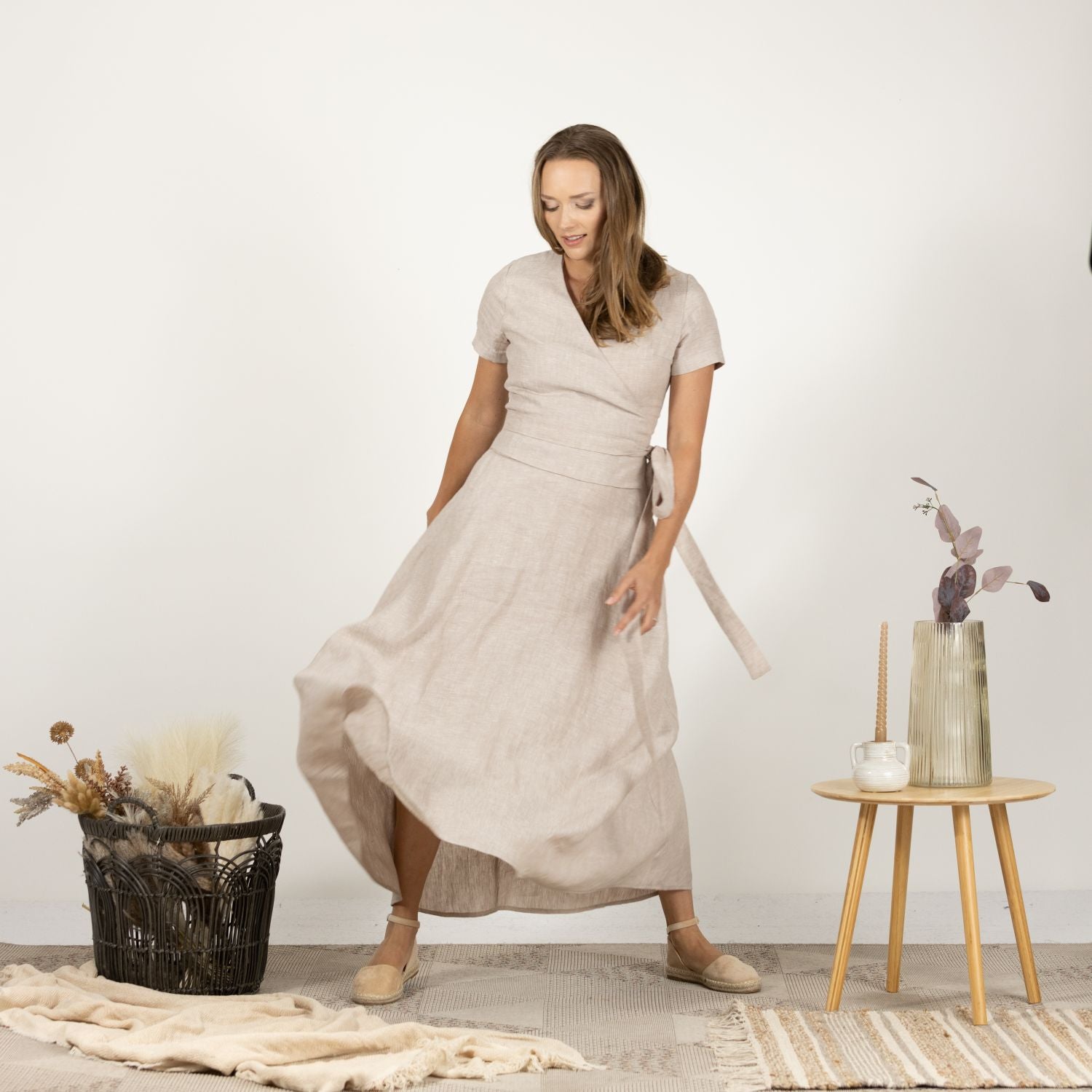 Model presenting the front of the Linen Wrap Around Dress with Waist Tie, emphasizing the dress's high-quality linen fabric.