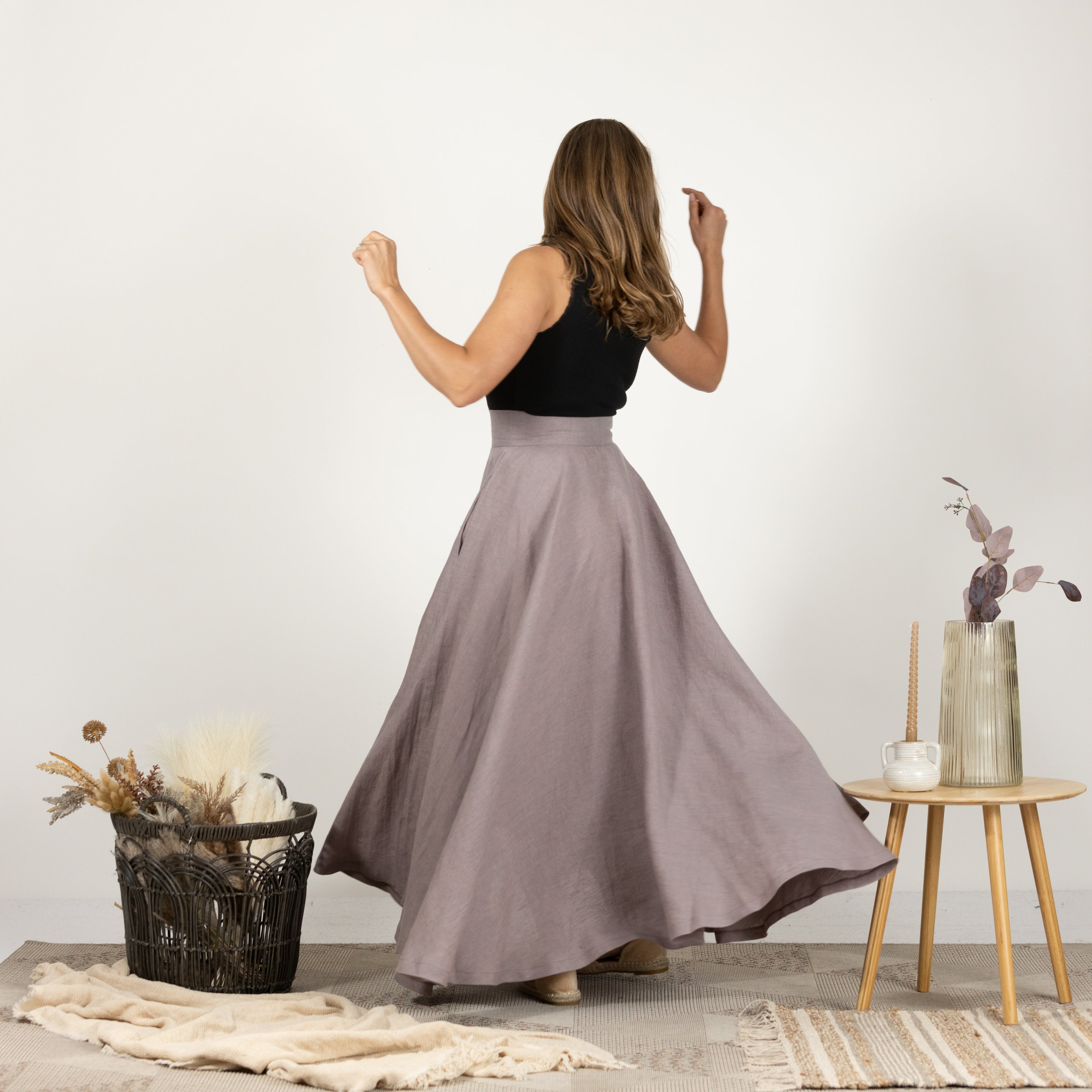 Back view of model in the Linen Flutter Skirt, showing the skirt's full length and flowing design.