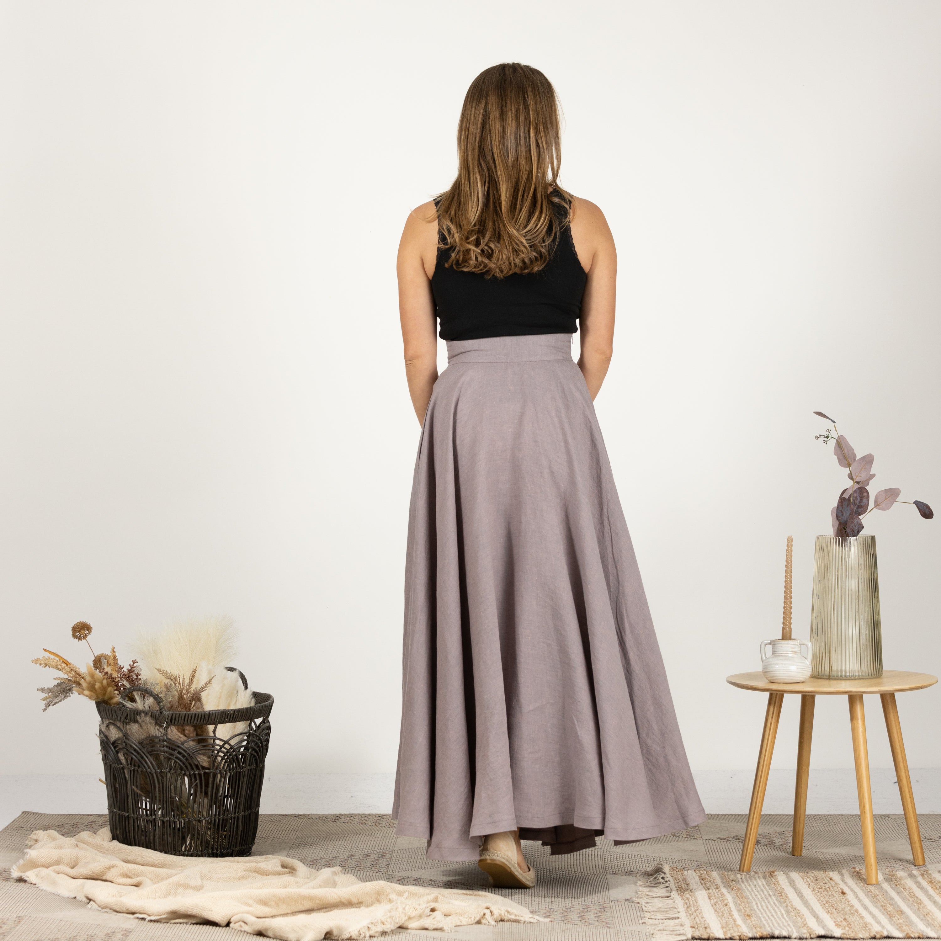 Rear perspective of the Linen Flutter Skirt on model, highlighting the skirt's graceful and timeless design.