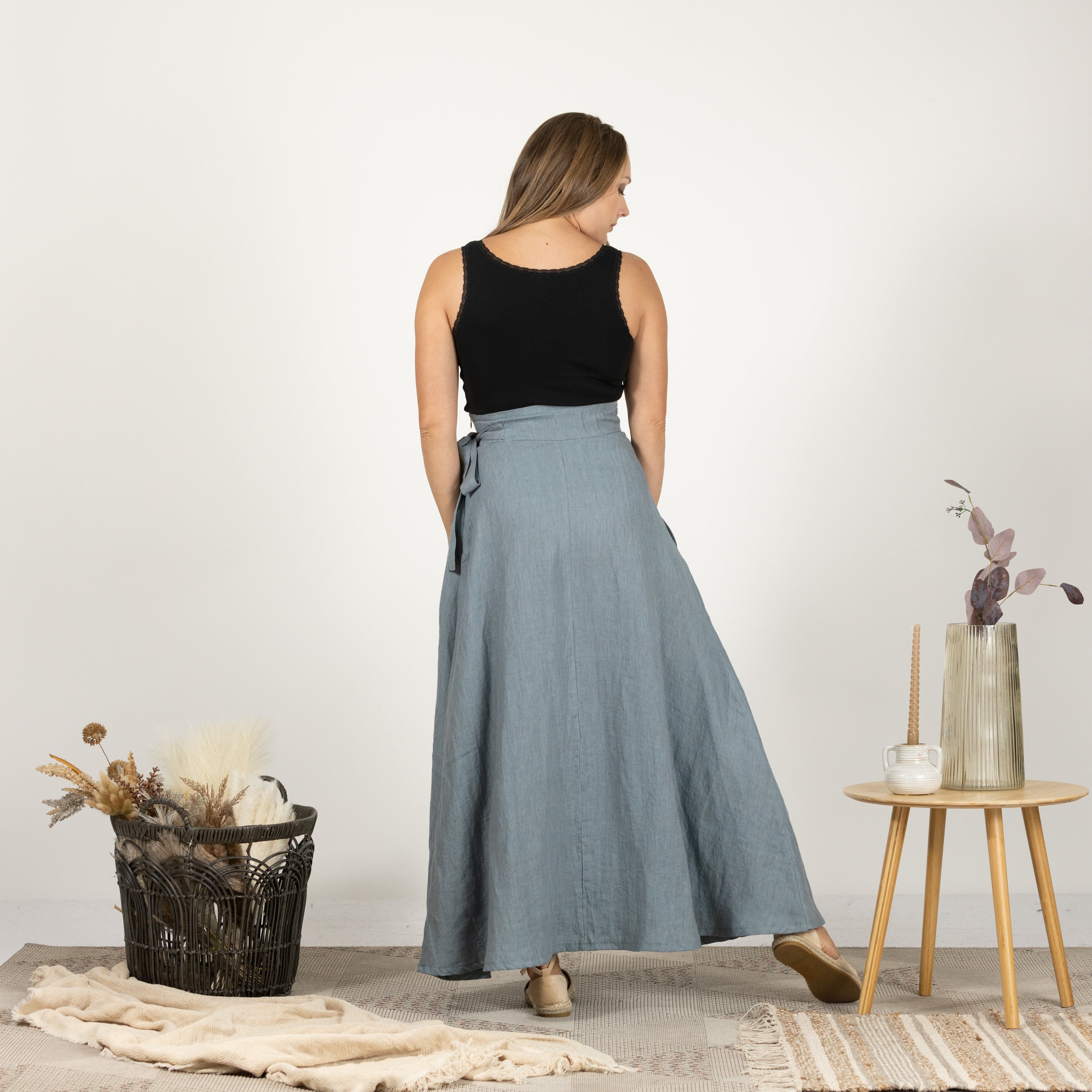 Model presenting the back of the Linen Wrap Around Skirt with Tie, emphasizing the high-quality linen fabric.