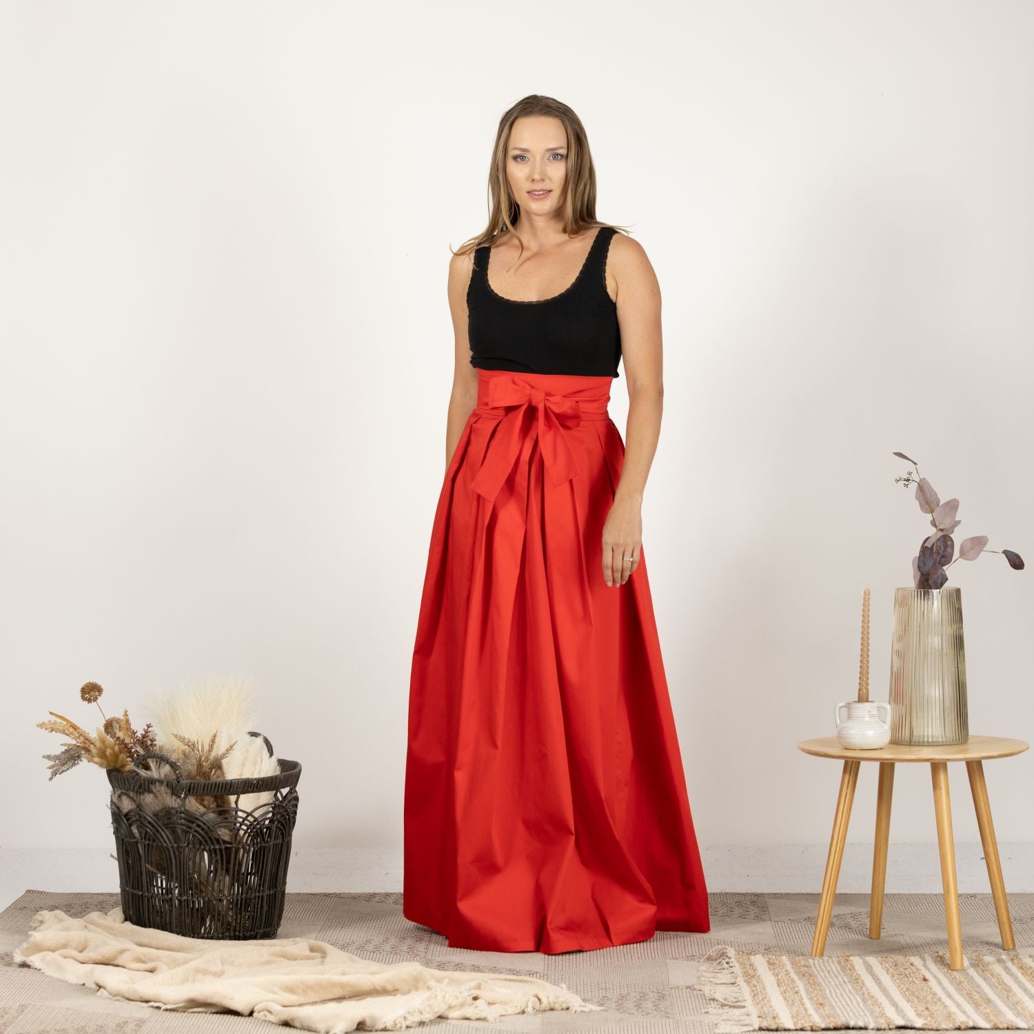 Front view of the High Waist Pleated Maxi Skirt in Red, showcasing the elegant pleated design and flattering high waistline for a feminine silhouette