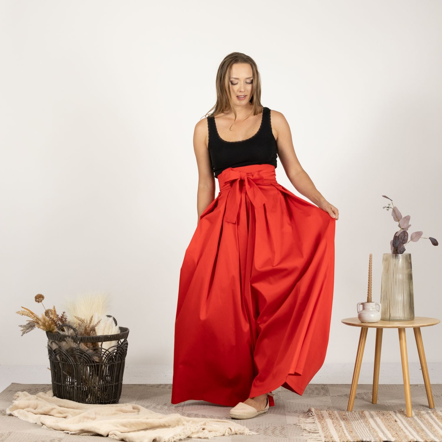 Front view of the High Waist Pleated Maxi Skirt in Red featuring a classic pleated design and a high waist for an elegant, feminine silhouette