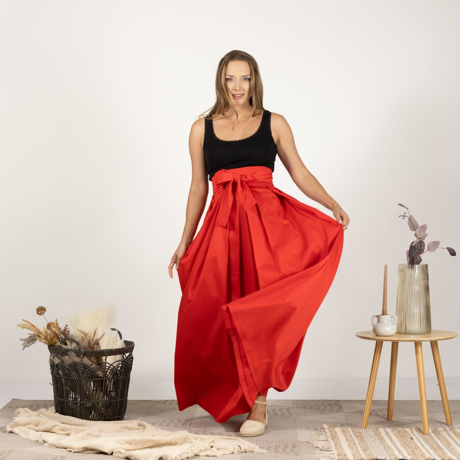 Close-up front view of the High Waist Pleated Maxi Skirt in Red, showcasing the precise pleats and smooth finish of the fabric