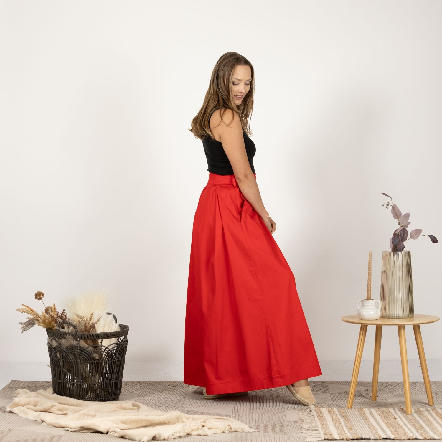 Side view of the model wearing the Cascading Cotton Skirt with Pockets, illustrating the cascading silhouette and high-waisted design.