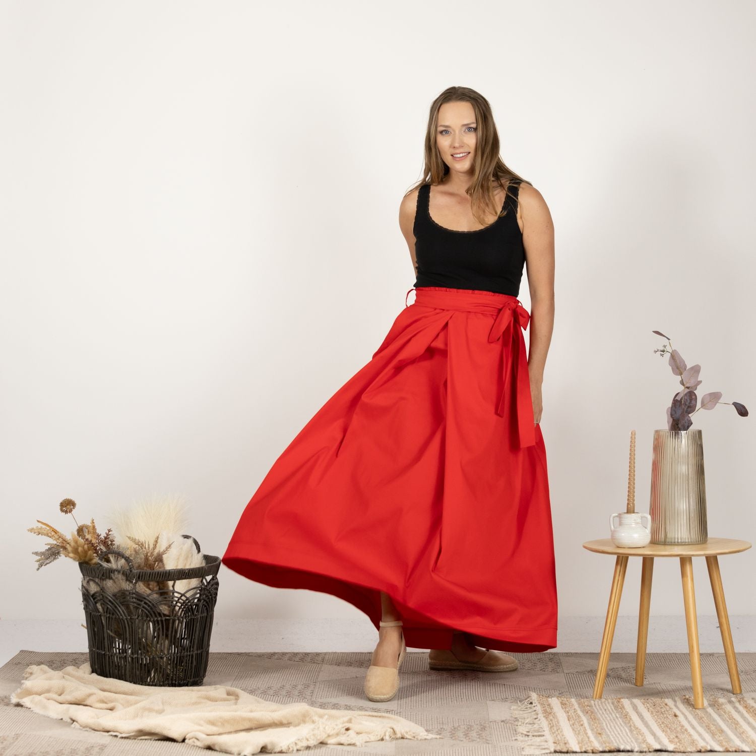 Front view of model wearing the Cascading Cotton Skirt with Pockets, showcasing the full length and cascading design.