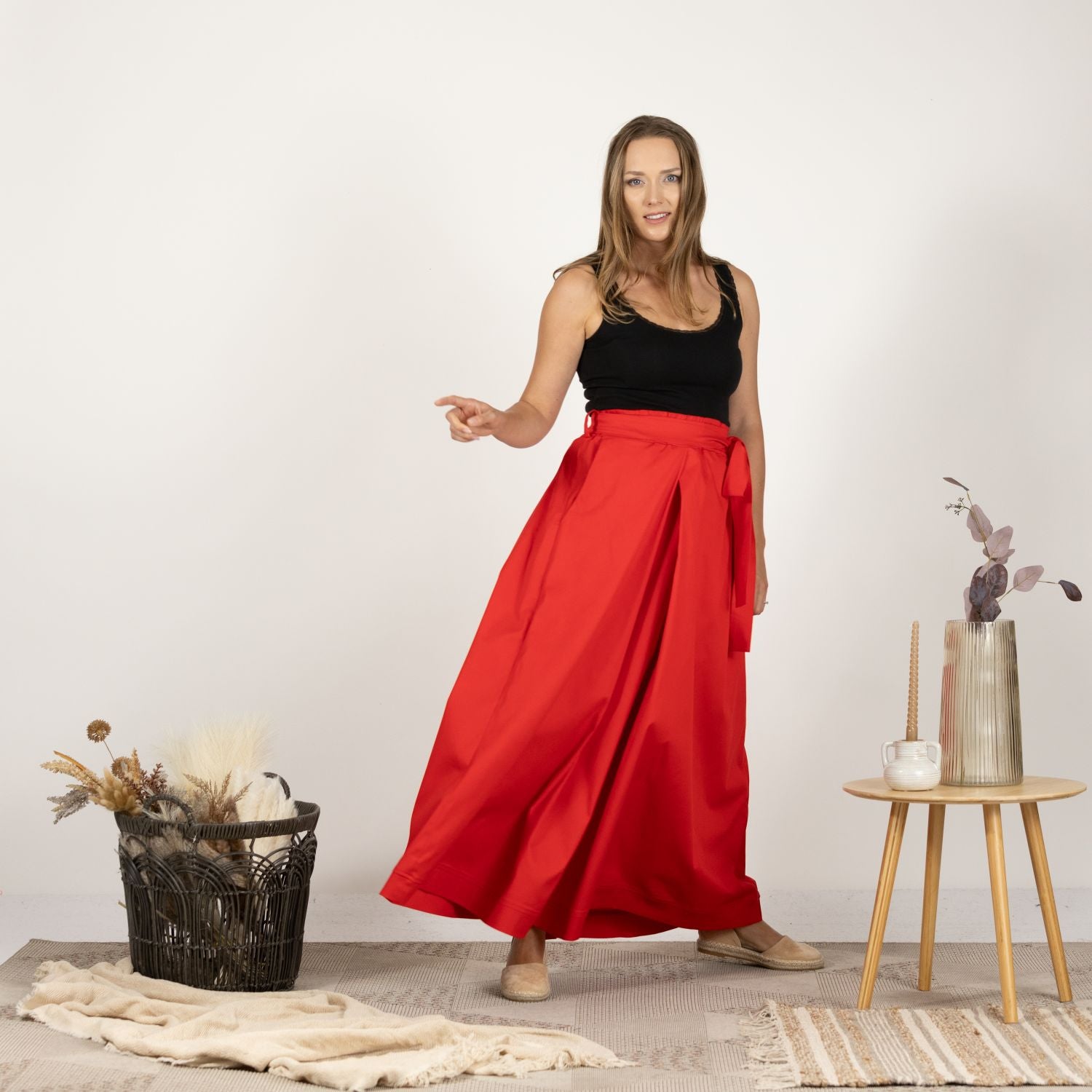 Front-facing image of the Cascading Cotton Skirt with Pockets, displaying the practical pockets and high-waisted fit.