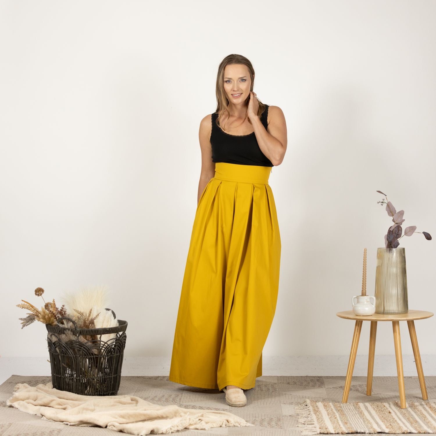 Model wearing the Cotton Skirt with High Rise from the front, highlighting the skirt's full length and elegant drape.