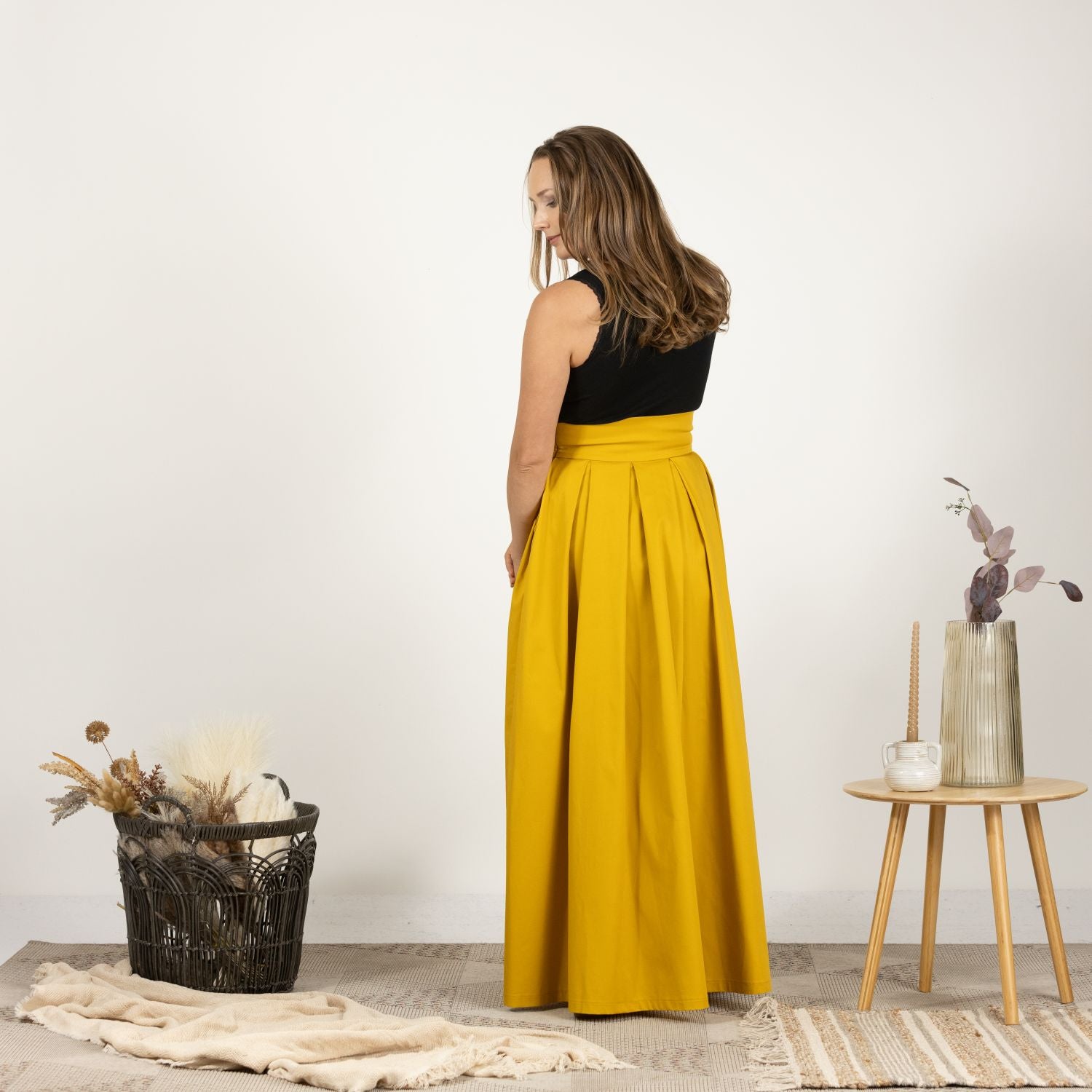 Side view of the model wearing the Cotton Skirt with High Rise, illustrating the high-rise waist and loose silhouette.