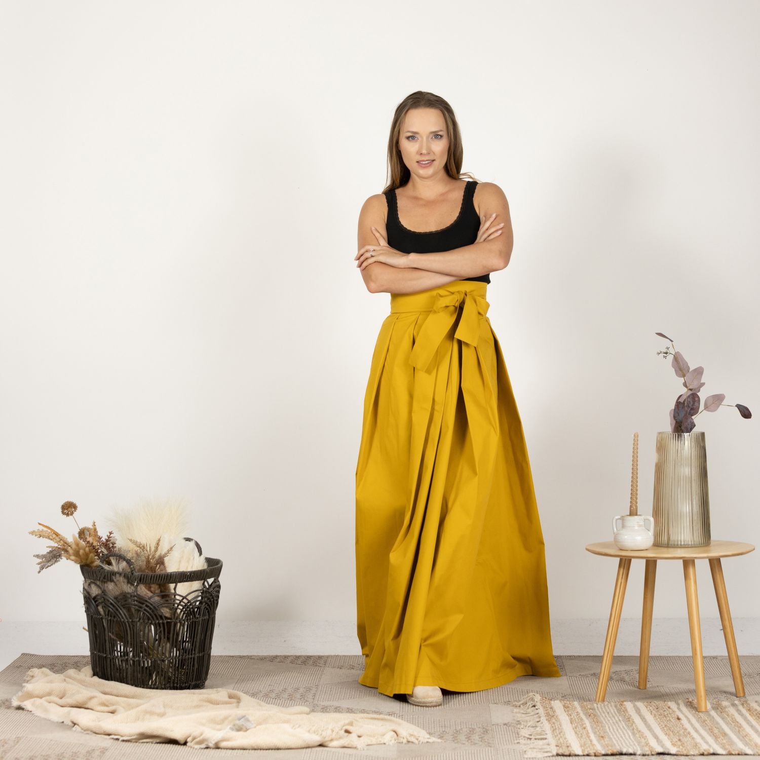 Front view of the High Waist Pleated Maxi Skirt in Deep Yellow, showcasing the vibrant color, elegant pleats, and high waistline for a stylish silhouette.