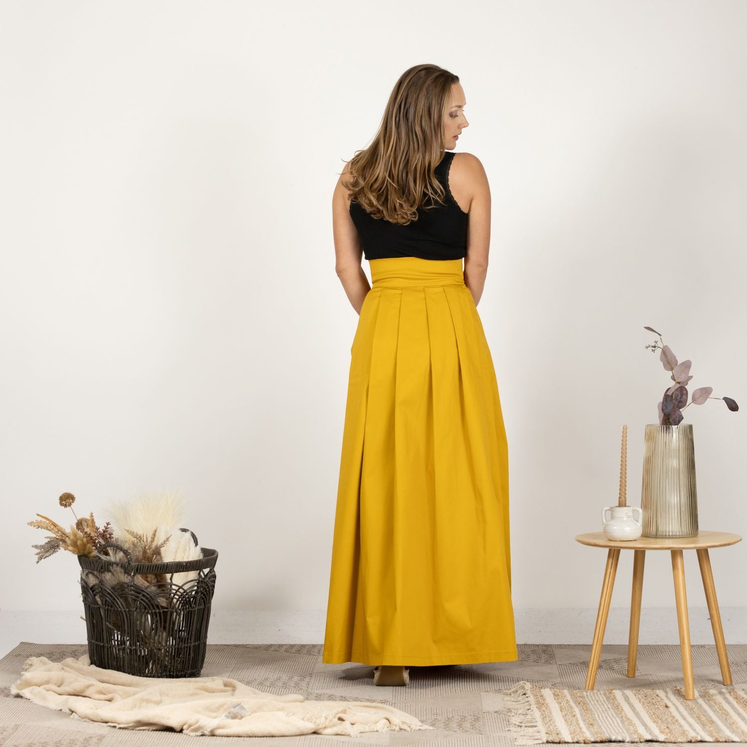 Back view of the High Waist Pleated Maxi Skirt in Deep Yellow, emphasizing the full pleats and the seamless high waist design.