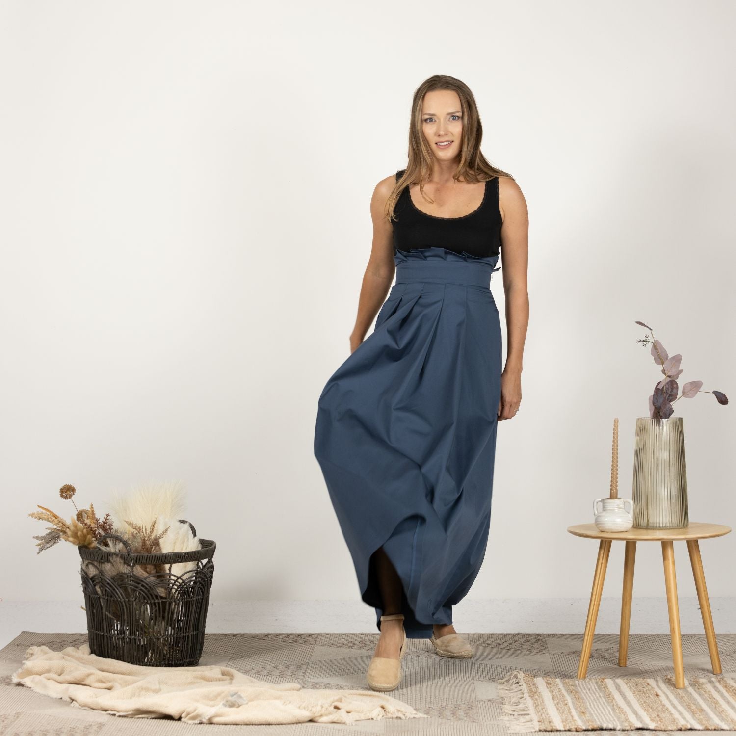 Front-facing image of the High-Rise Pleated Cotton Skirt, displaying the elegant full-length and sophisticated pleats.