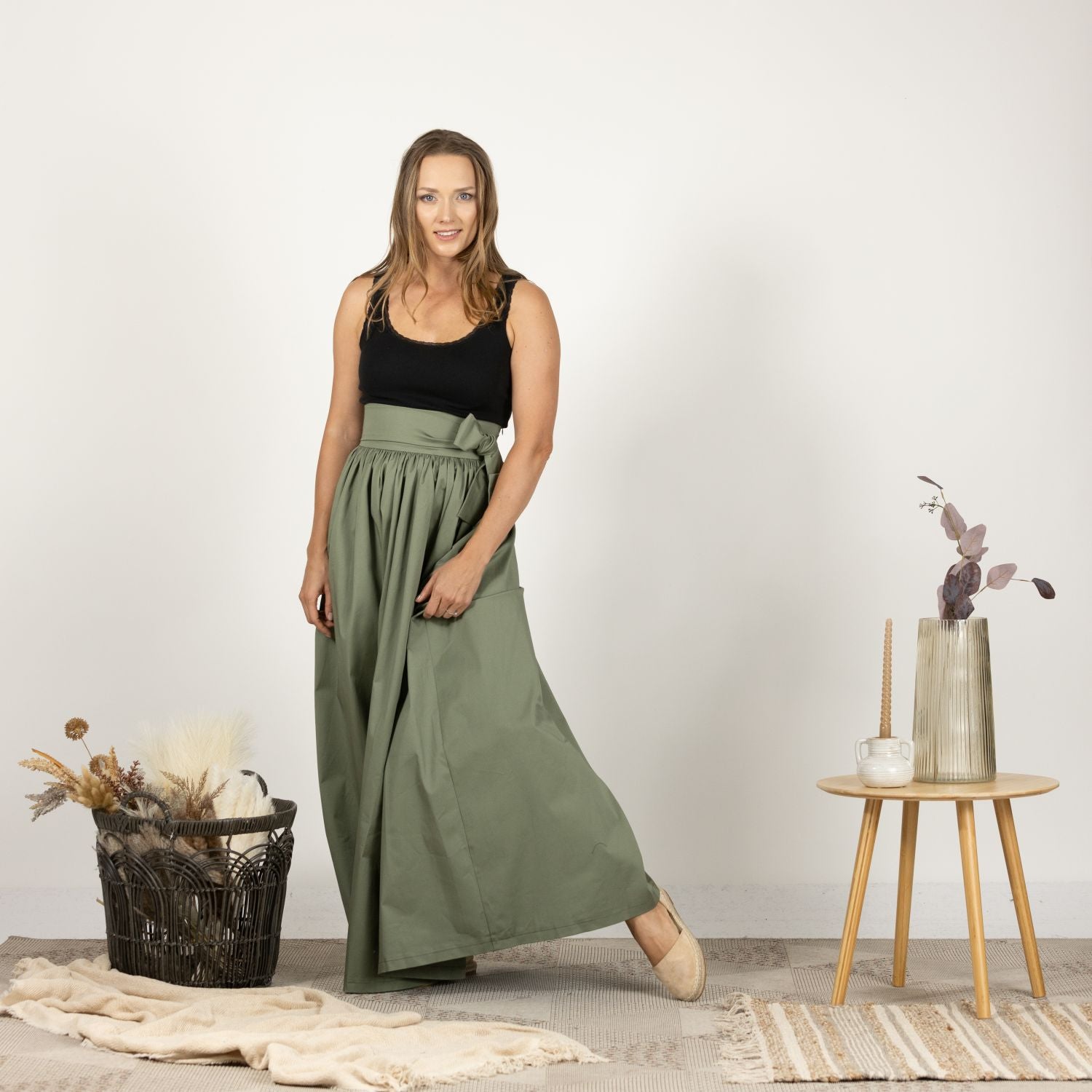 Full-length front view of the Loose High Waist Skirt in Sage Green, displaying the graceful flow of the fabric and the stylish high waist design.