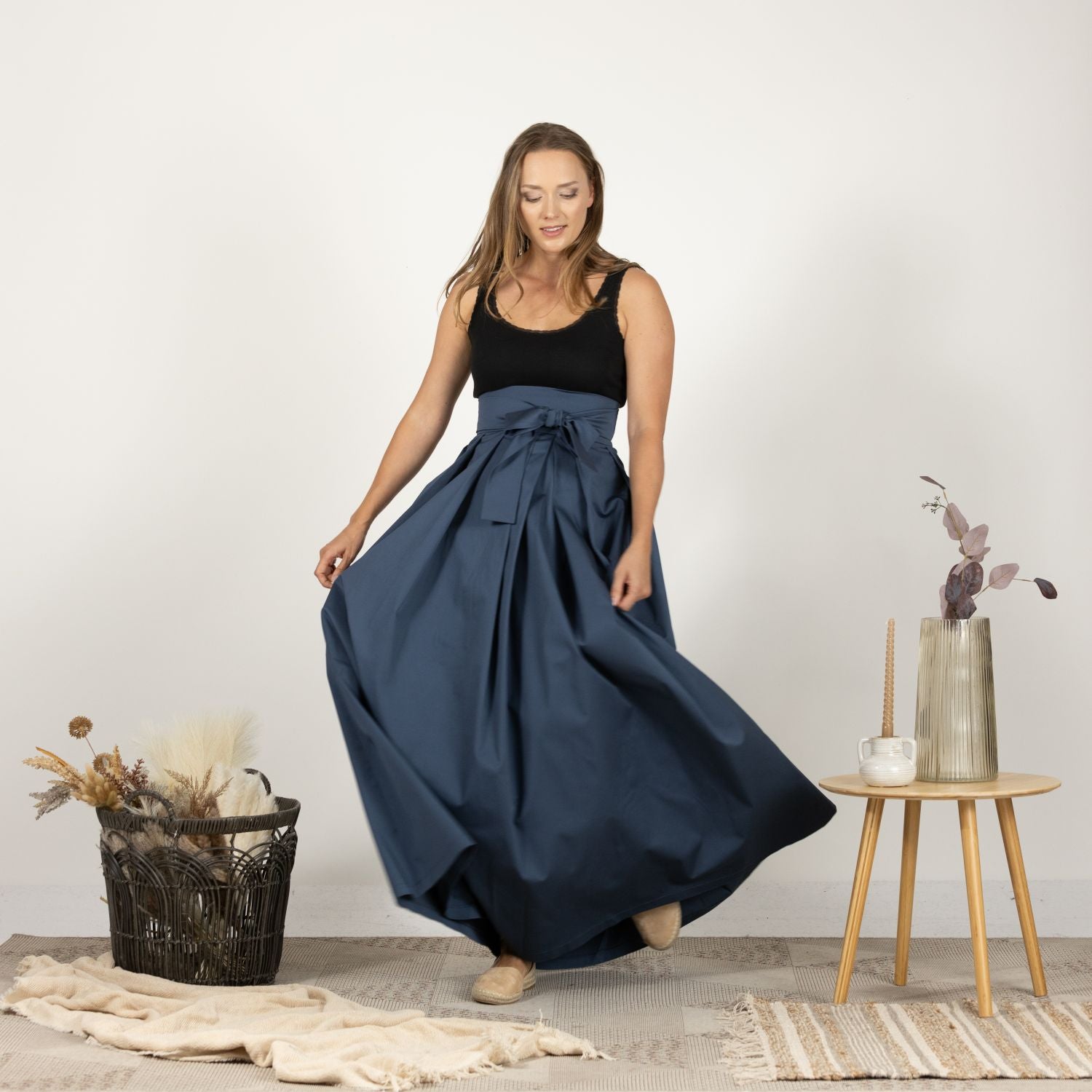 Close-up front view of the High Waist Pleated Maxi Skirt in Slate Blue, focusing on the crisp pleats and the luxurious texture of the fabric.