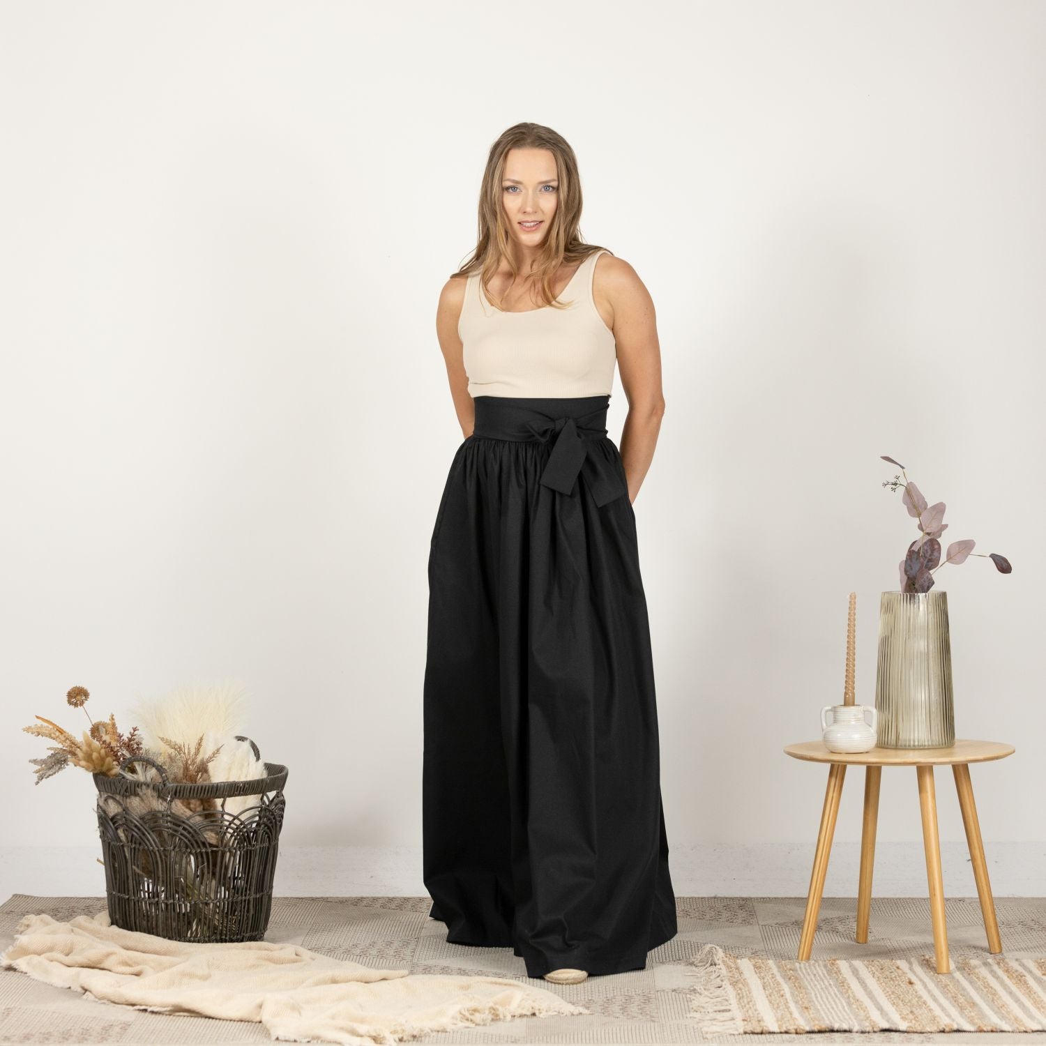 Full-length front view of the Loose High Waist Skirt in Black, showcasing its sophisticated high waist and flowing silhouette, perfect for both casual and formal looks.