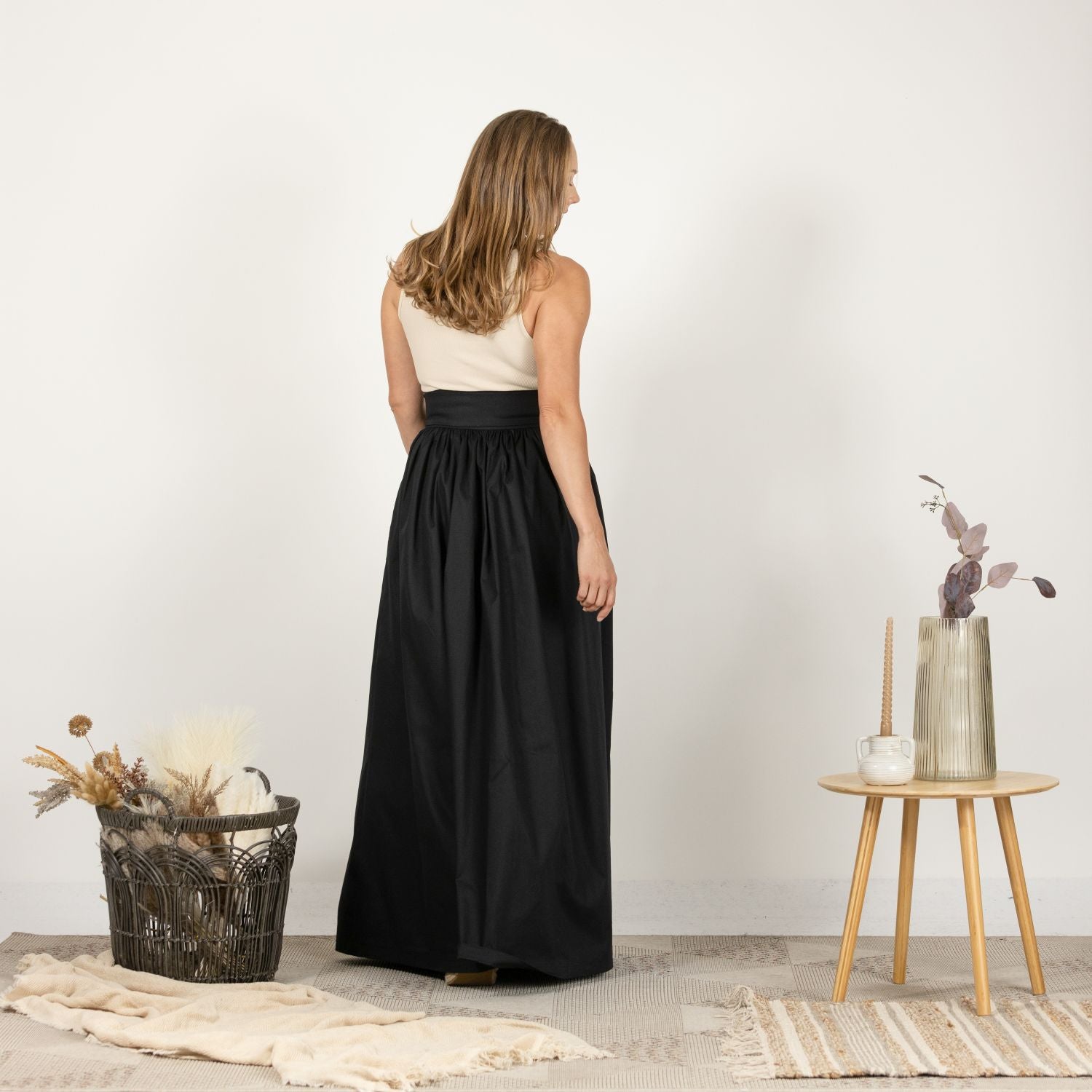 Back view of the Loose High Waist Skirt in Black, highlighting the high waist and flowy, full-length silhouette.