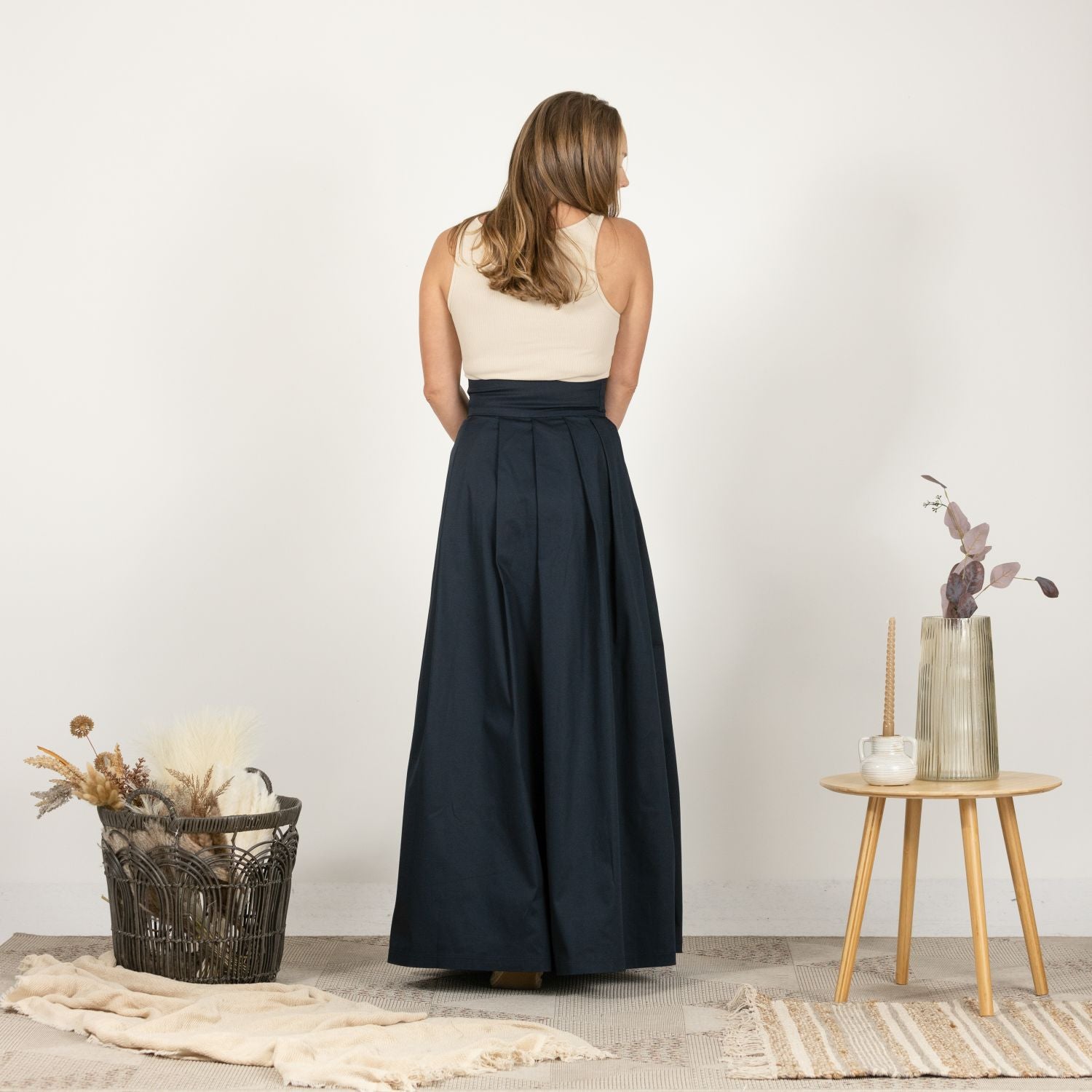 Back view of the High Waist Pleated Maxi Skirt in Dark Blue, showcasing the full pleats and tailored high waist design.