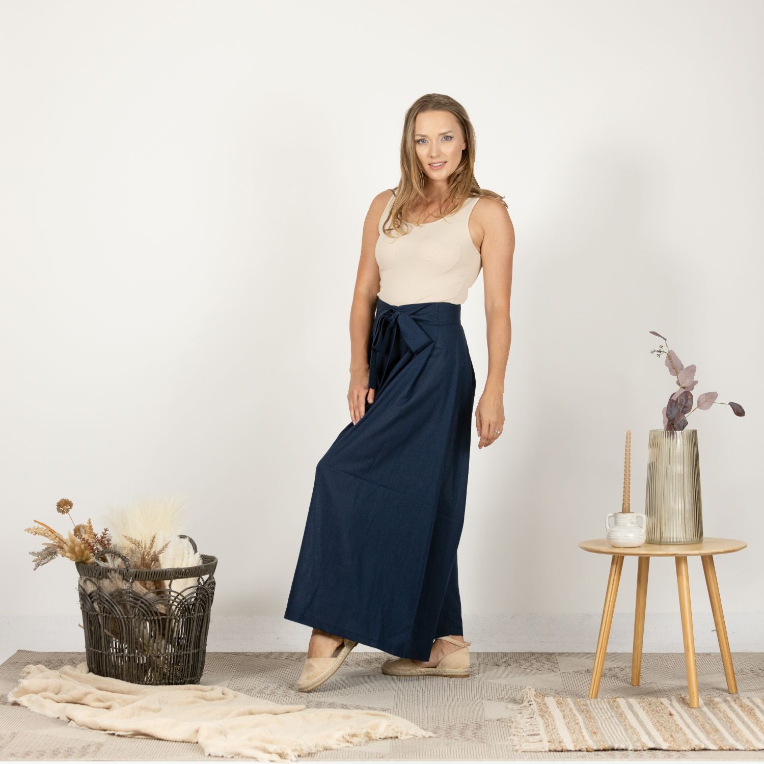 Side profile of the Dark Blue Melange Wide Leg Linen Pants, emphasizing the high waist and the flattering palazzo style cut.