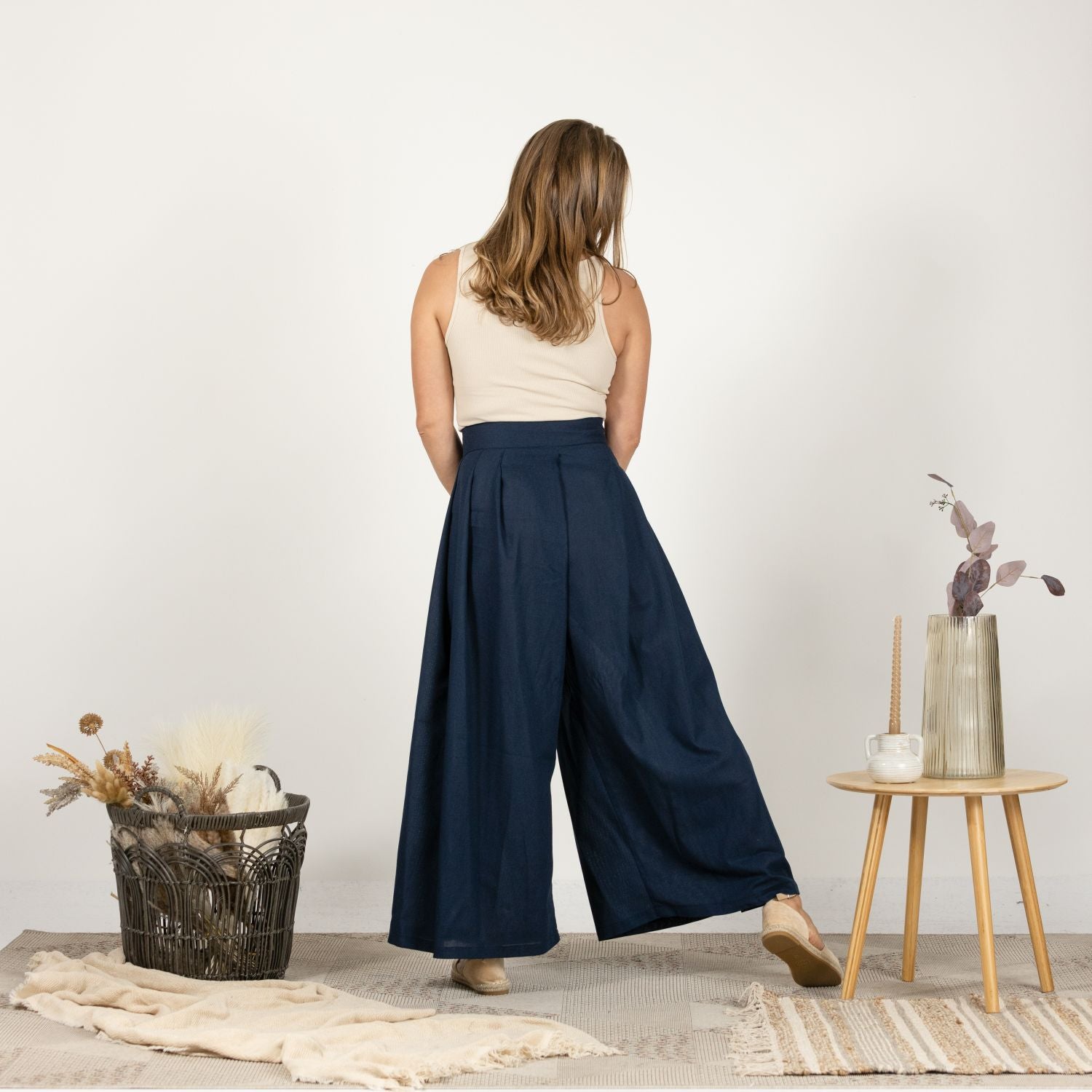 Back view of the Dark Blue Melange Wide Leg Linen Pants, showcasing the seamless design and the graceful flow of the wide-leg silhouette.