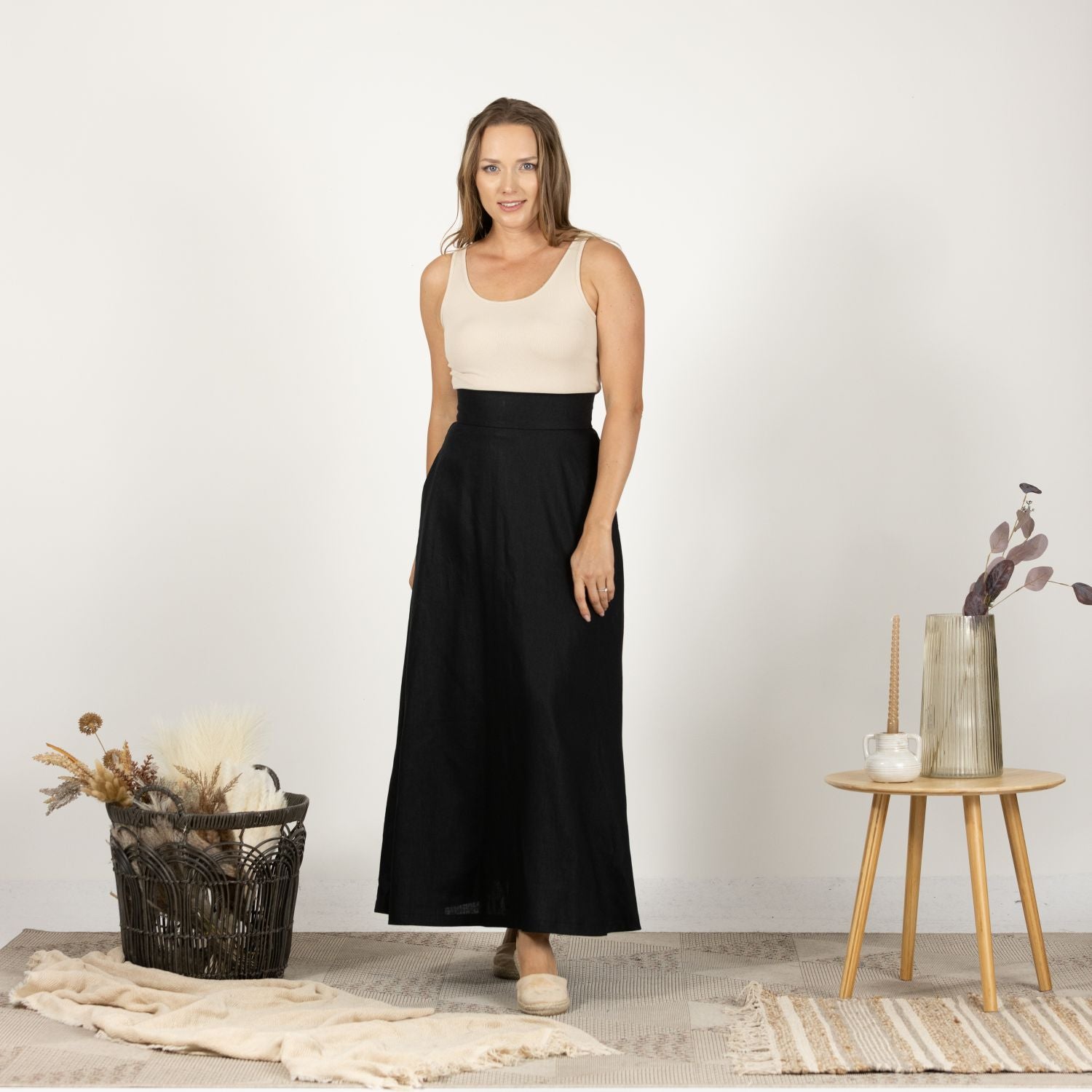 Front view of the Black Minimalist High Waist Linen Maxi Skirt, showcasing the sleek and simple design with a flattering high waist and flowing maxi length.