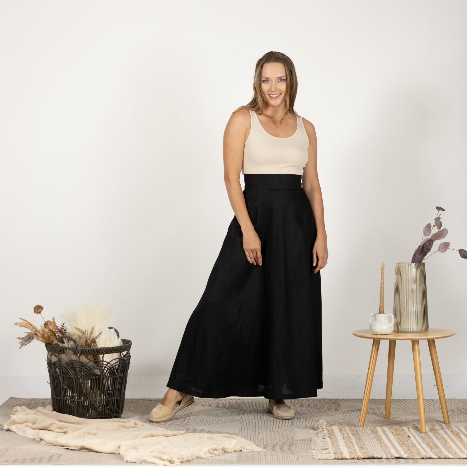 Full-length front view of the Black Minimalist High Waist Linen Maxi Skirt, highlighting the elegant and versatile design that pairs well with both casual and formal outfits.