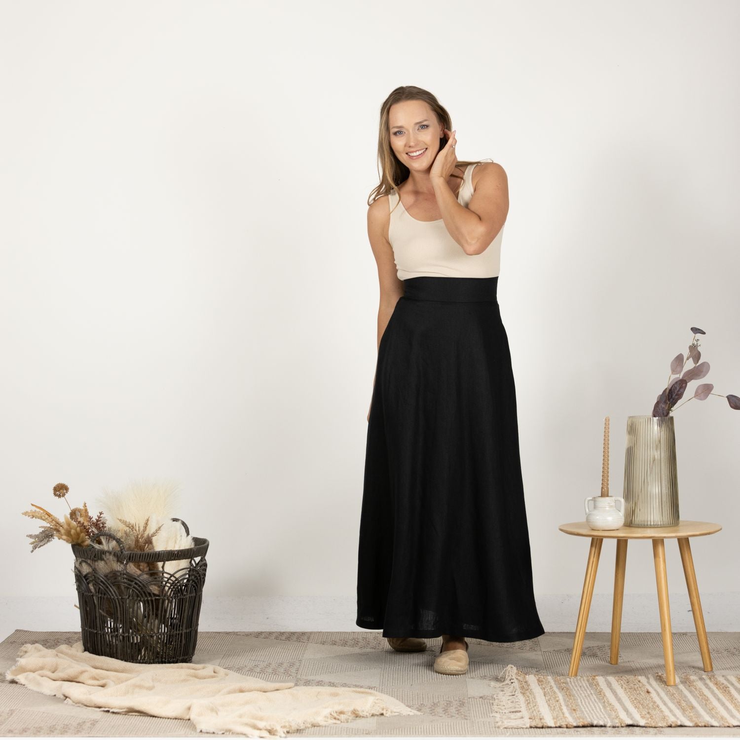 Close-up front view of the Black Minimalist High Waist Linen Maxi Skirt, focusing on the fine Italian linen fabric and the smooth, clean lines of the minimalist design.