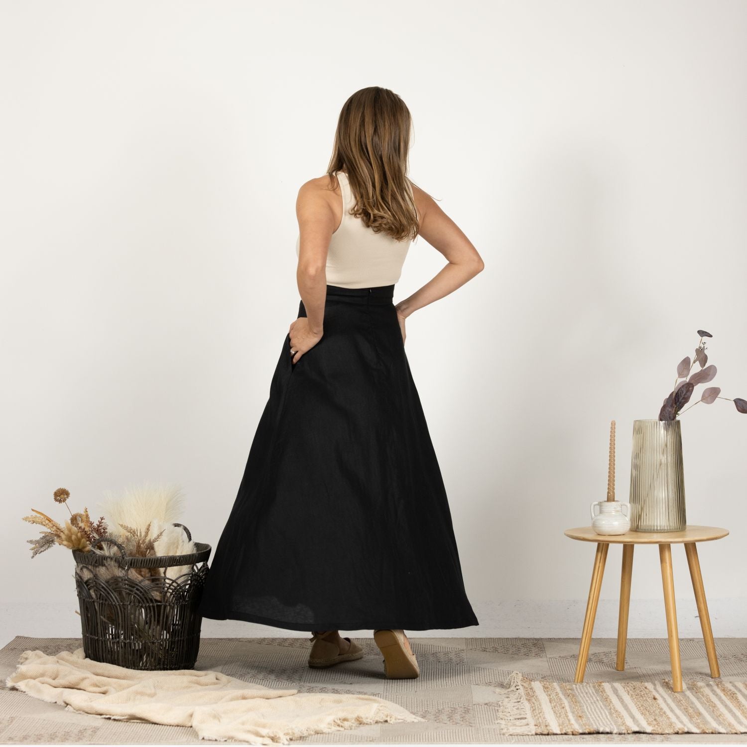 Back view of the Black Minimalist High Waist Linen Maxi Skirt, showcasing the flattering high waistline and the subtle drape of the Italian linen fabric.