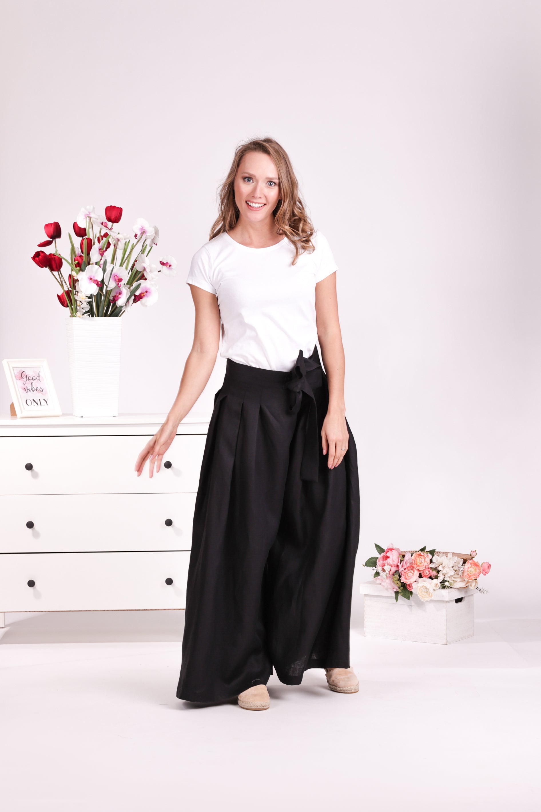 Relaxed black linen trousers with bow detail